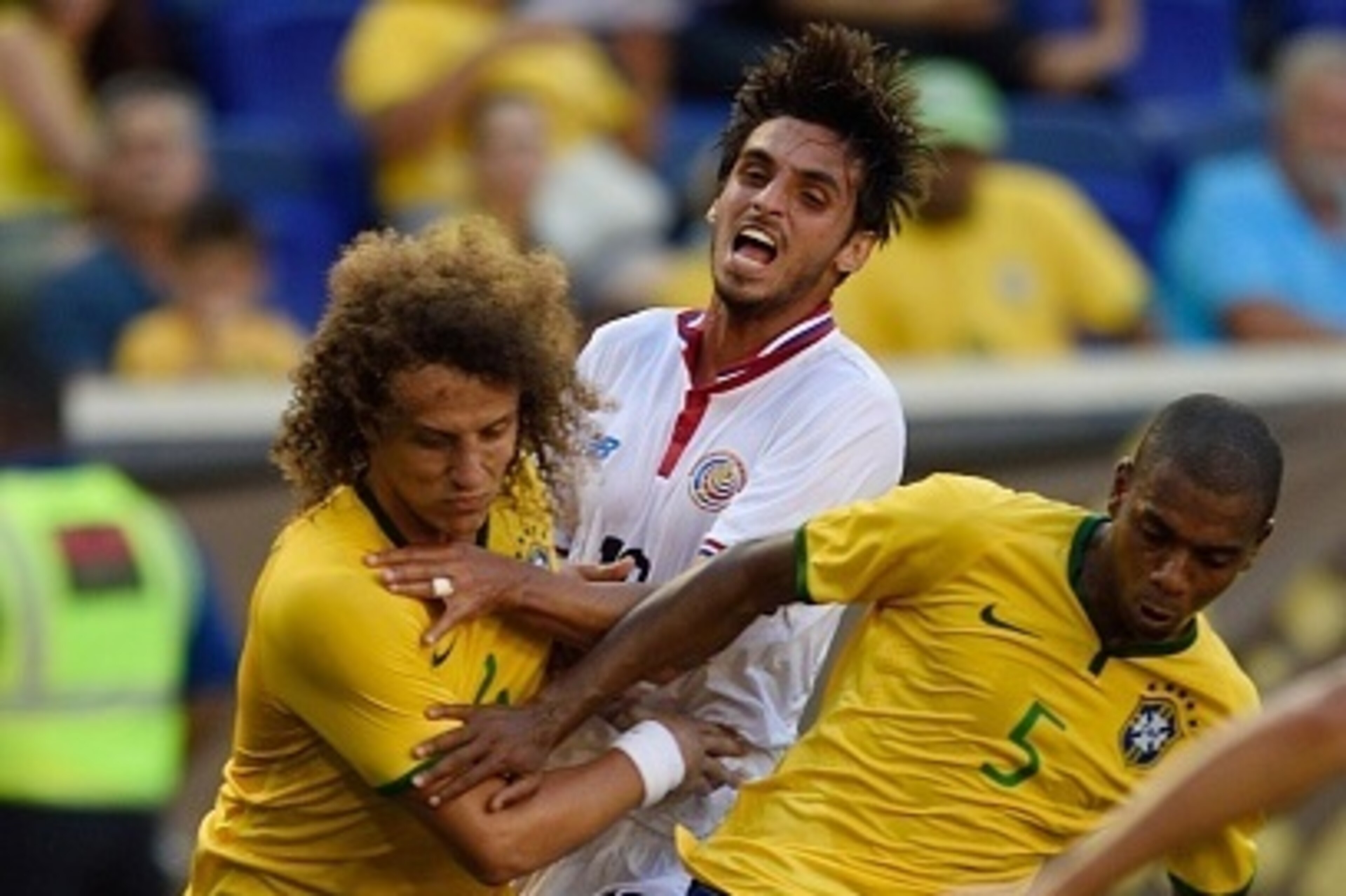 Costa Rica's Bryan Ruiz (C) gets squeezed between Brazil's David Luiz (L) and Brazil's Fernandinho during the friendly match between Brazil and Costa Rica on September 5, 2015 at Red Bulls Arena in Harrison, New Jersey. AFP PHOTO/DON EMMERT        (Photo 