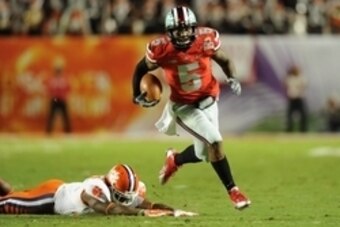 Jan 3, 2014; Miami Gardens, FL, USA; Ohio State Buckeyes quarterback Braxton Miller (5) runs past Clemson Tigers safety Robert Smith (27) for a touchdown in the first half during the 2014 Orange Bowl college football game at Sun Life Stadium. Mandatory Cr