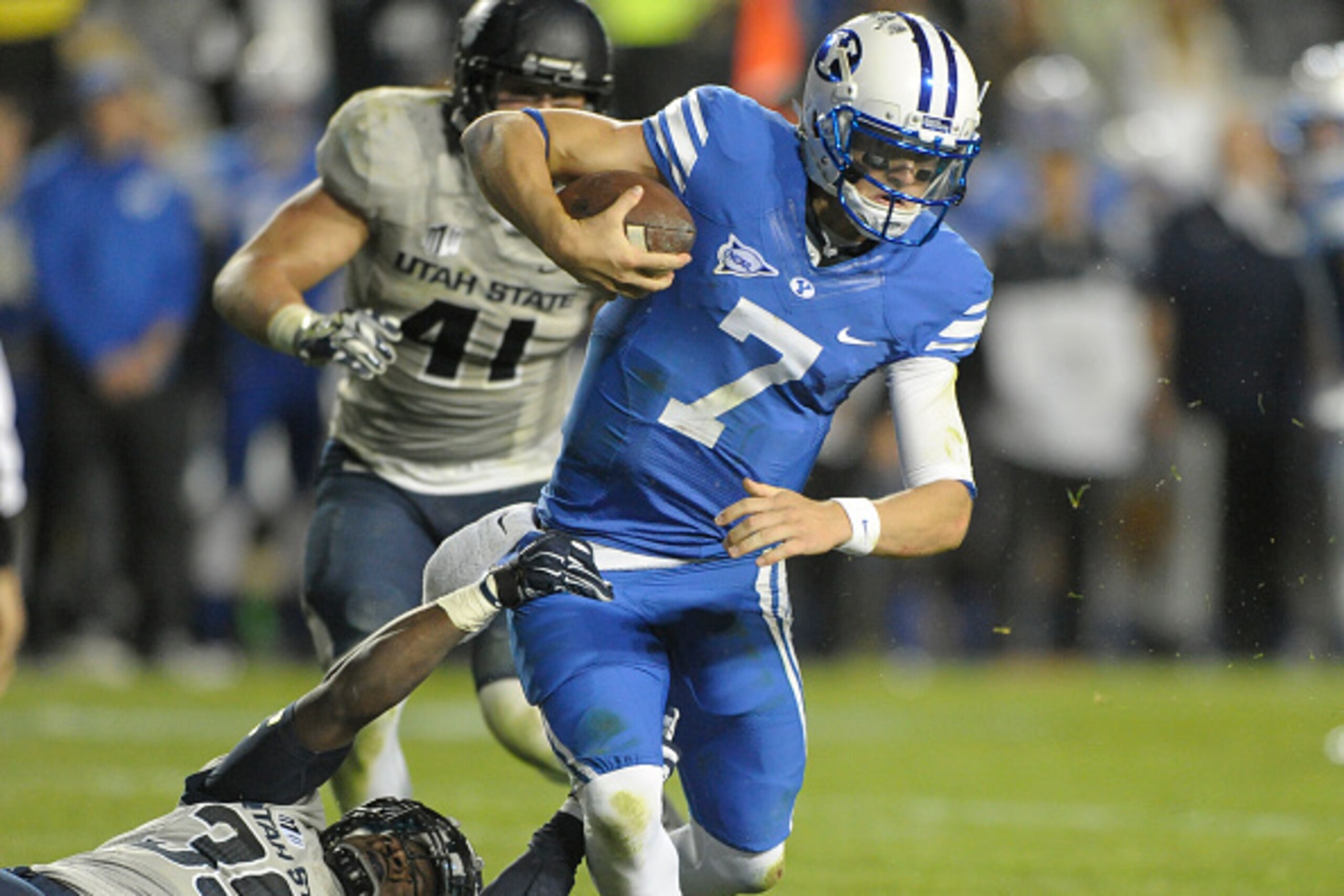 PROVO, UT - OCTOBER 3: Quarterback Christian Stewart #7 of the Brigham Young Cougars, who replaced the injured Taysom Hill, is sacked by Torrey Green #39 of the Utah State Aggies, during the fourth quarter of their game at LaVell Edwards Stadium on Octobe
