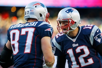 Dec 14, 2014; Foxborough, MA, USA; New England Patriots quarterback Tom Brady (12) celebrates with tight end Rob Gronkowski (87) after catching the ball to score a touchdown during the second half against the Miami Dolphins at Gillette Stadium. The Patrio