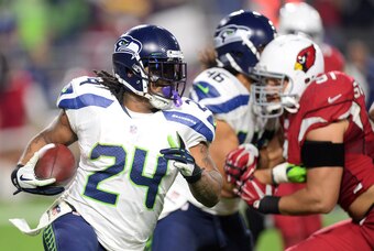 Dec 21, 2014; Glendale, AZ, USA; Seattle Seahawks running back Marshawn Lynch (24) rushes the ball against the Arizona Cardinals at University of Phoenix Stadium. The Seahawks won 35-6. Mandatory Credit: Joe Camporeale-USA TODAY Sports