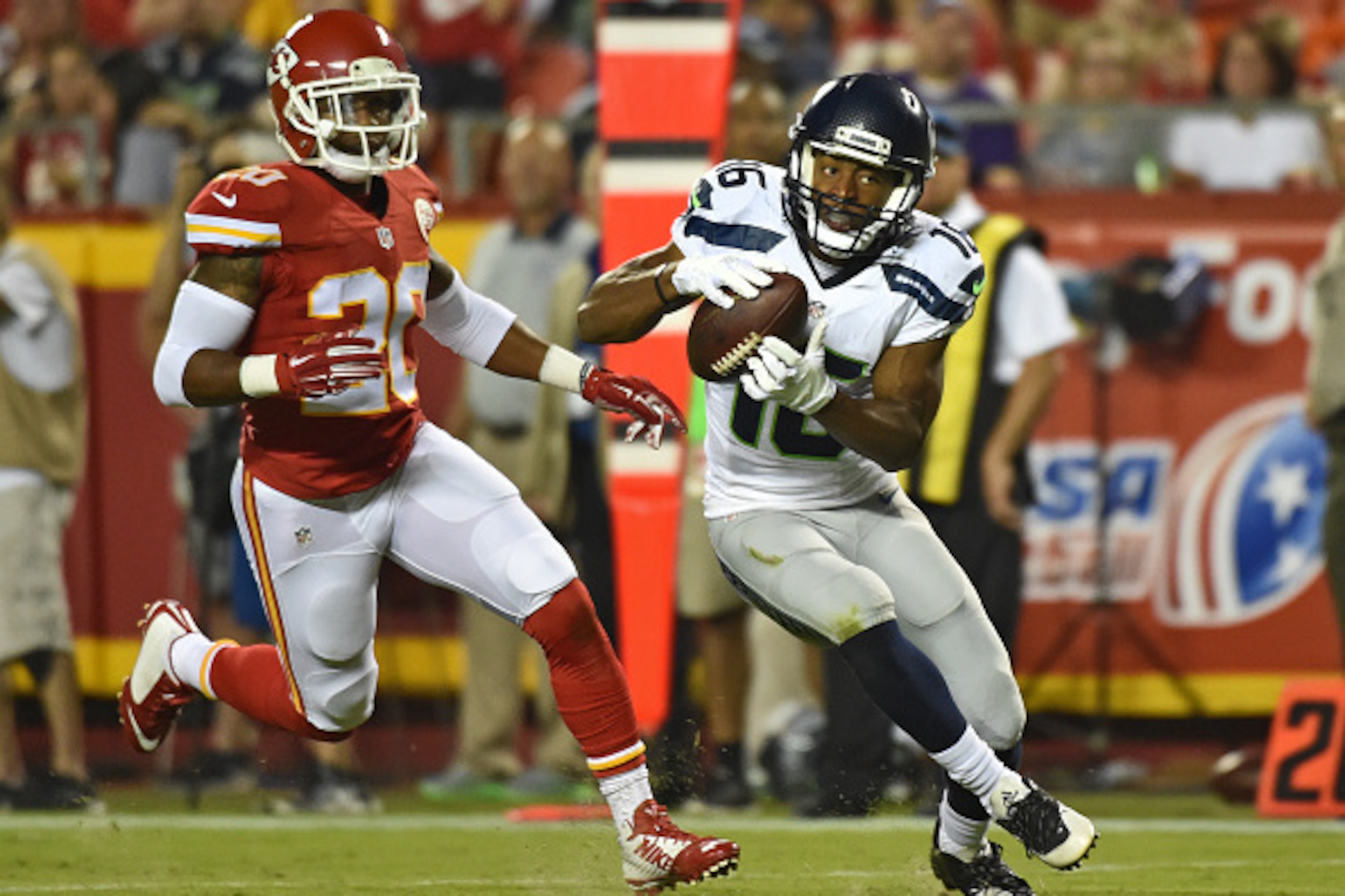 KANSAS CITY, MO - AUGUST 21:  Wide receiver Tyler Lockett #16 of the Seattle Seahawks turns up field after catching a pass against defensive back Steven Nelson #20 of the Kansas City Chiefs during the second half of a preseason game at Arrowhead Stadium o