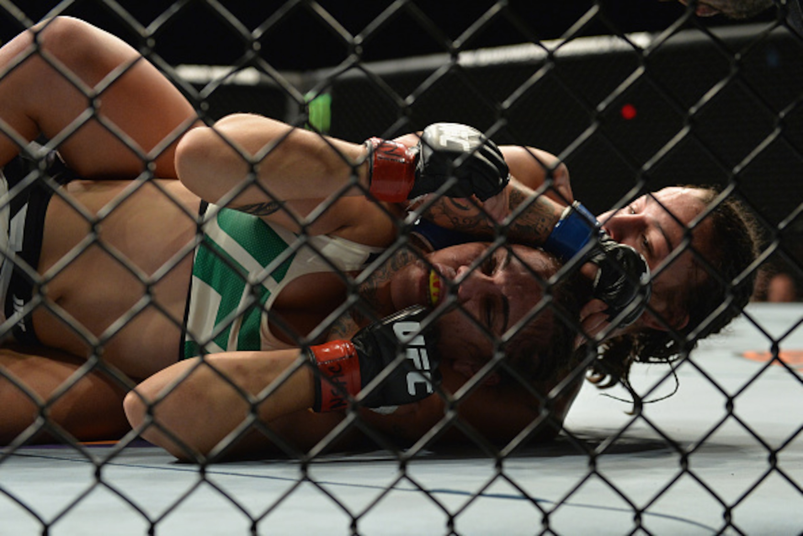 LAS VEGAS, NV - SEPTEMBER 05: Raquel Pennington (back) attempts to submit Jessica Andrade in their women's bantamweight bout during the UFC 191 event inside MGM Grand Garden Arena on September 5, 2015 in Las Vegas, Nevada.  (Photo by Brandon Magnus/Zuffa 