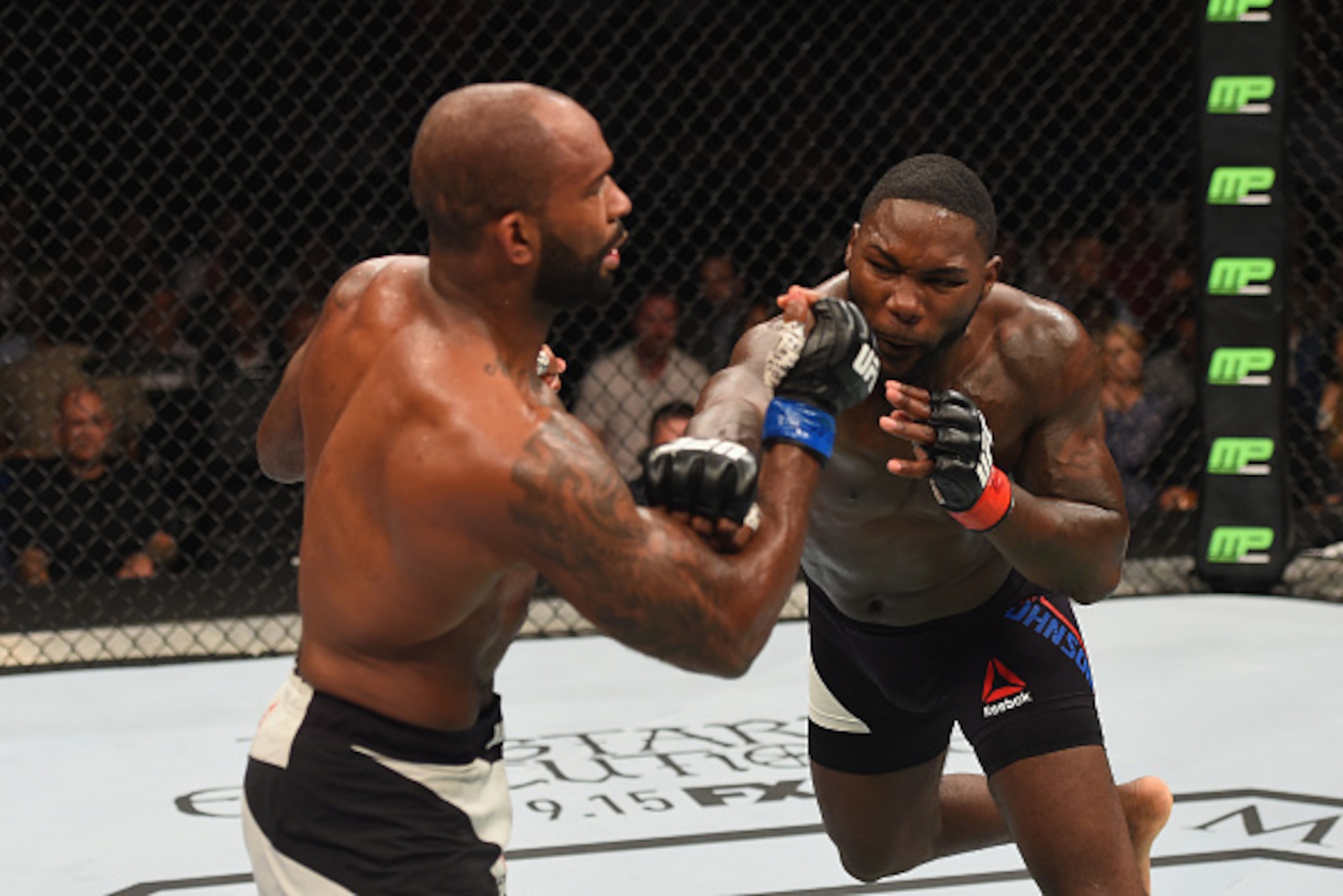 LAS VEGAS, NV - SEPTEMBER 05: (R-L) Anthony Johnson punches Jimi Manuwa in their light heavyweight bout during the UFC 191 event inside MGM Grand Garden Arena on September 5, 2015 in Las Vegas, Nevada.  (Photo by Josh Hedges/Zuffa LLC/Zuffa LLC via Getty 