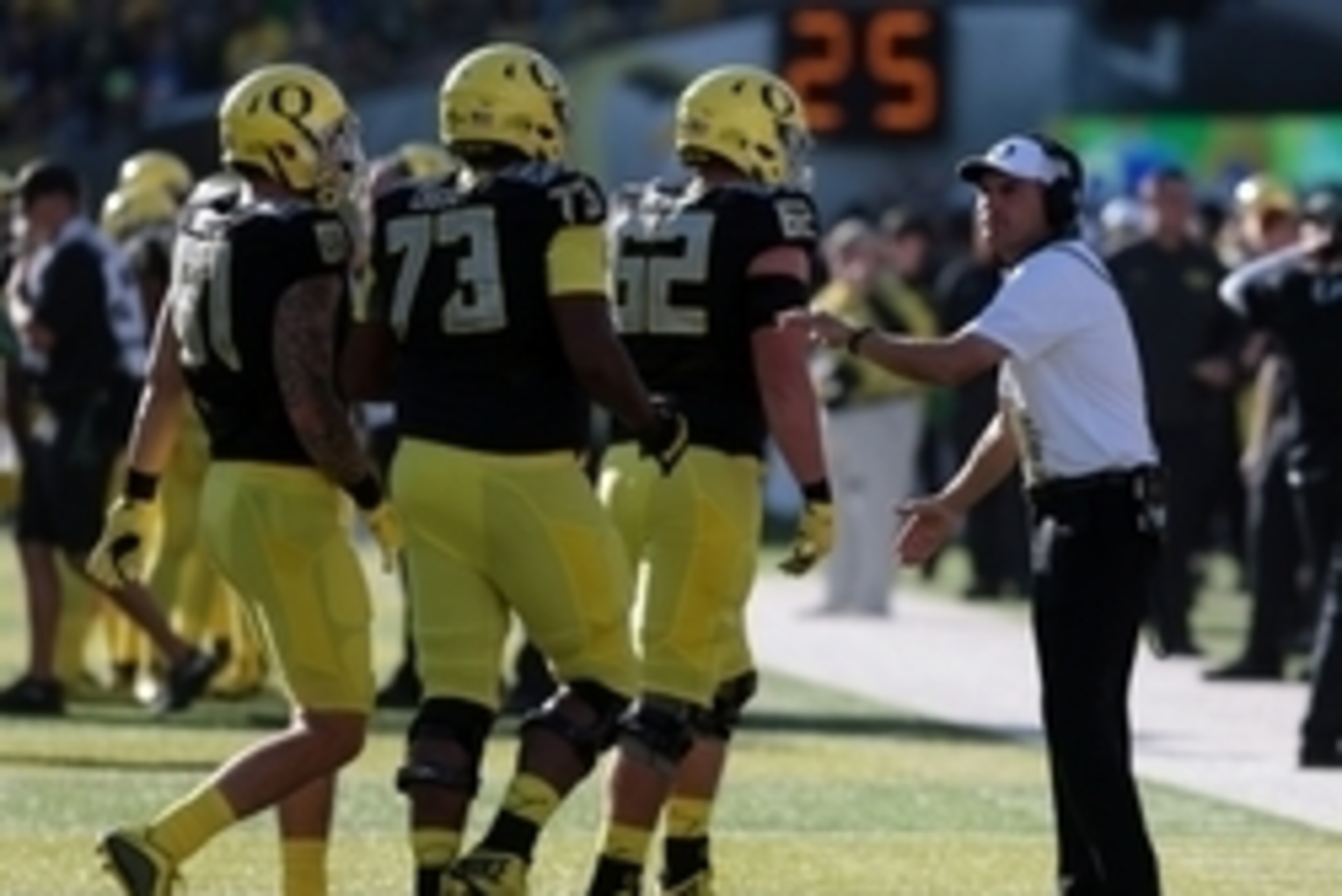 Sep 5, 2015; Eugene, OR, USA; Oregon Ducks head coach Mark Helfrich talks on the side line with Oregon Ducks offensive lineman Matt Pierson (62) Oregon Ducks offensive lineman Tyrell Crosby (73) and Oregon Ducks tight end Evan Baylis (81) against the East