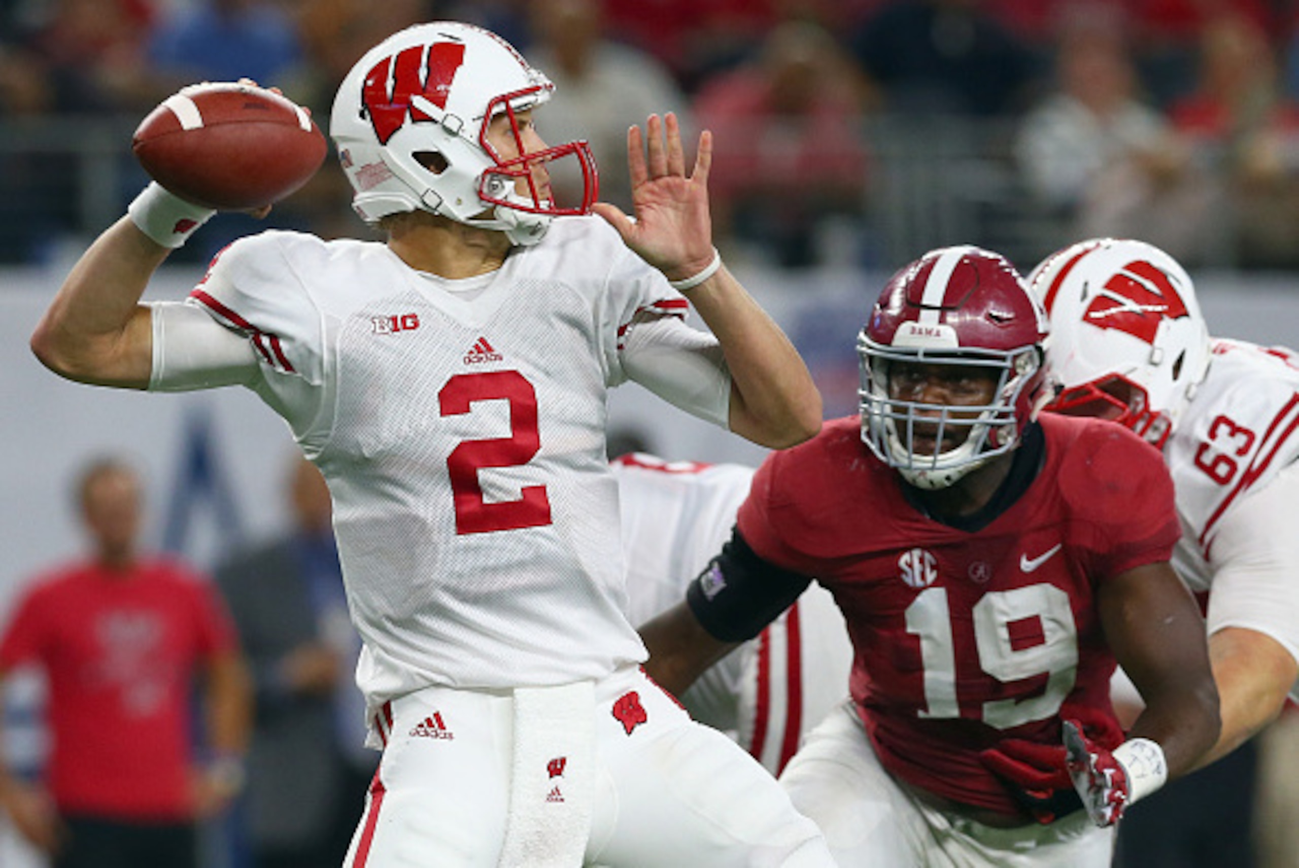 ARLINGTON, TX - SEPTEMBER 05:  Joel Stave #2 of the Wisconsin Badgers looks for an ope receiver under pressure from Reggie Ragland #19 of the Alabama Crimson Tide in the second half during The Advocare Classic at AT&T Stadium on September 5, 2015 in Arlin