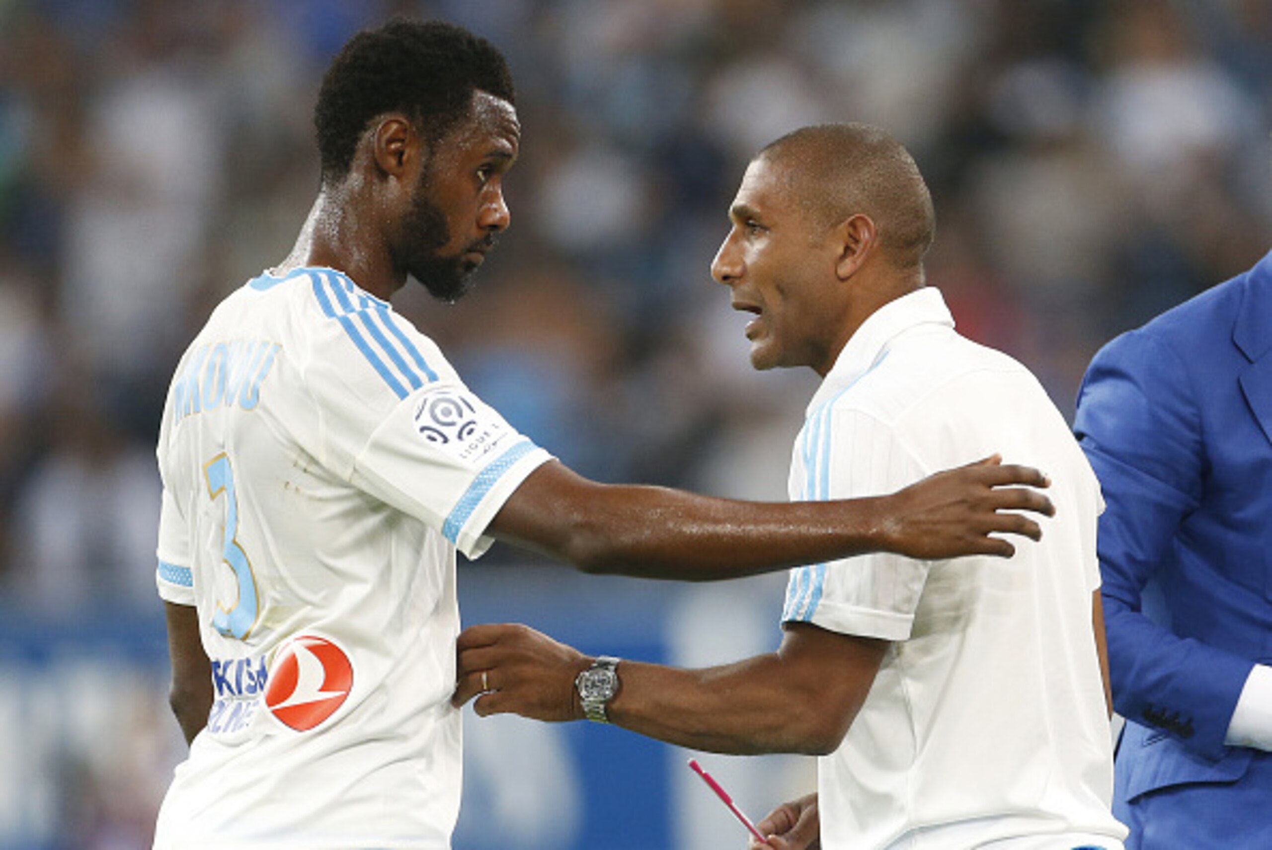 MARSEILLE - AUGUST 23: Nicolas N'Koulou of OM talks to assistant coach of OM Franck Passi during the French Ligue 1 match between Olympique de Marseille (OM) and Troyes ESTAC at New Stade Velodrome on August 23, 2015 in Marseille, France. (Photo by Jean C