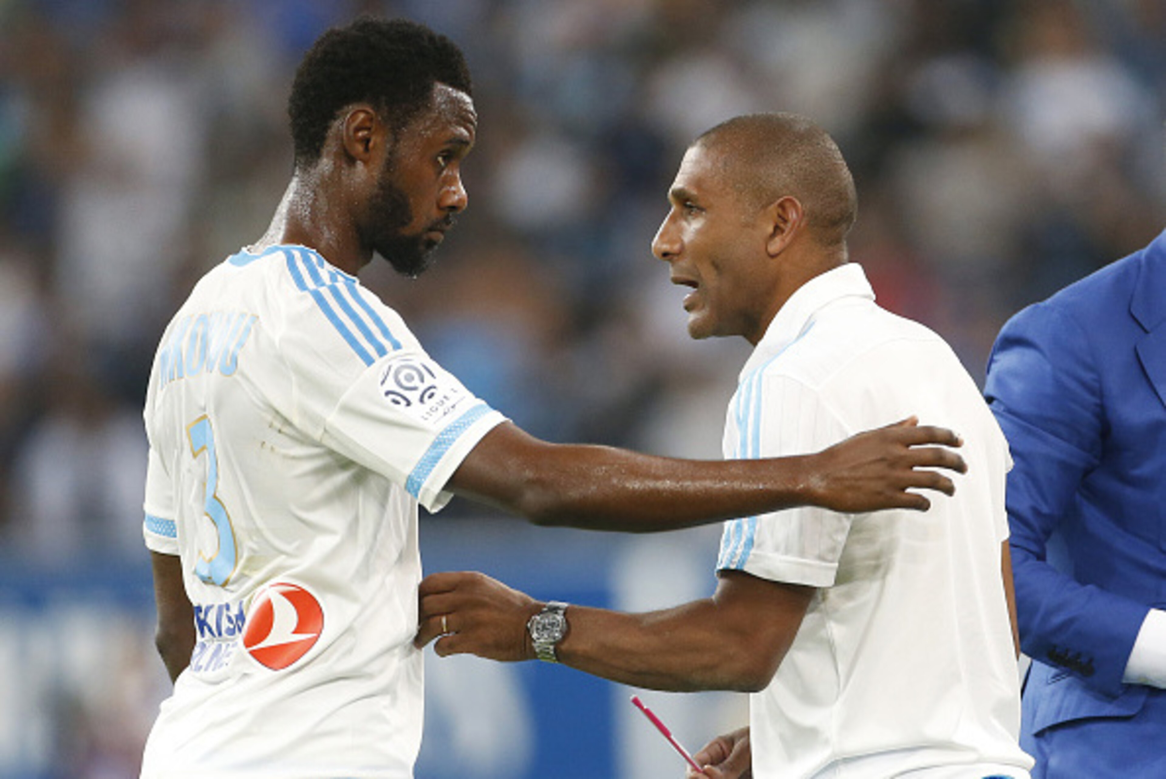 MARSEILLE - AUGUST 23: Nicolas N'Koulou of OM talks to assistant coach of OM Franck Passi during the French Ligue 1 match between Olympique de Marseille (OM) and Troyes ESTAC at New Stade Velodrome on August 23, 2015 in Marseille, France. (Photo by Jean C