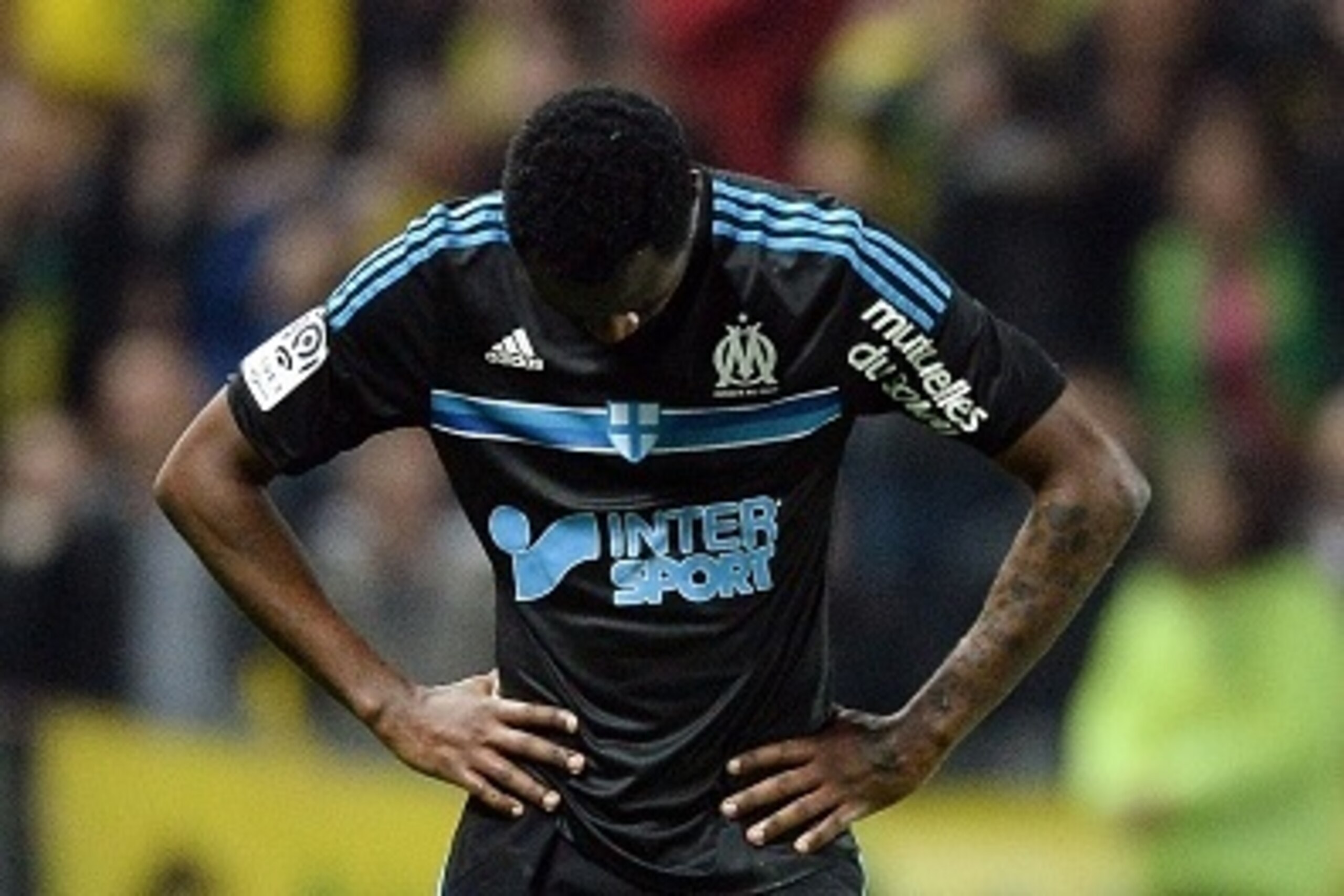 Marseille's Cameroonian defender Nicolas Nkoulou reacts at the end of the French L1 football match between Nantes and Marseille on April 17, 2015 at the Beaujoire stadium in Nantes, western France. AFP PHOTO / JEAN-SEBASTIEN EVRARD        (Photo credit sh