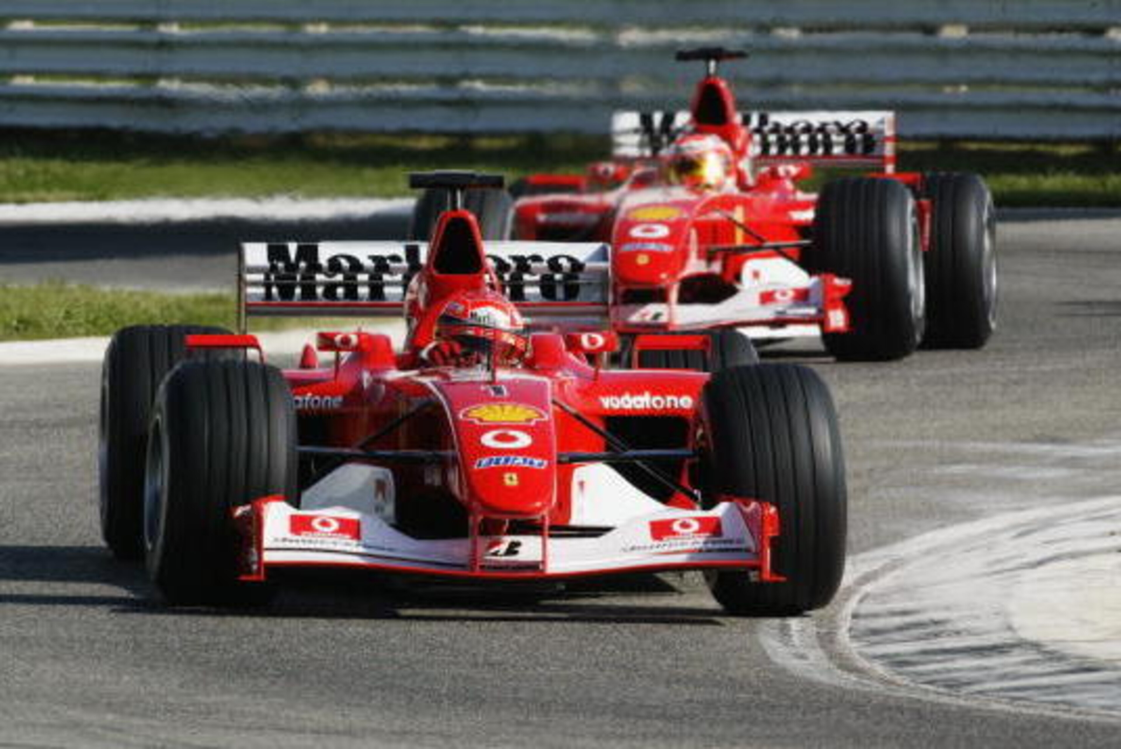 MISANO- OCTOBER 20:  Ferrari driver Michael Schumacher of Germany leads Rubens Barrichello of Brazil during a team parade of Formula One Ferrari team at the Tutte le Ferrari a Misano day held on October 20, 2002 at the Autodromo Misano, in Misano, Italy. 