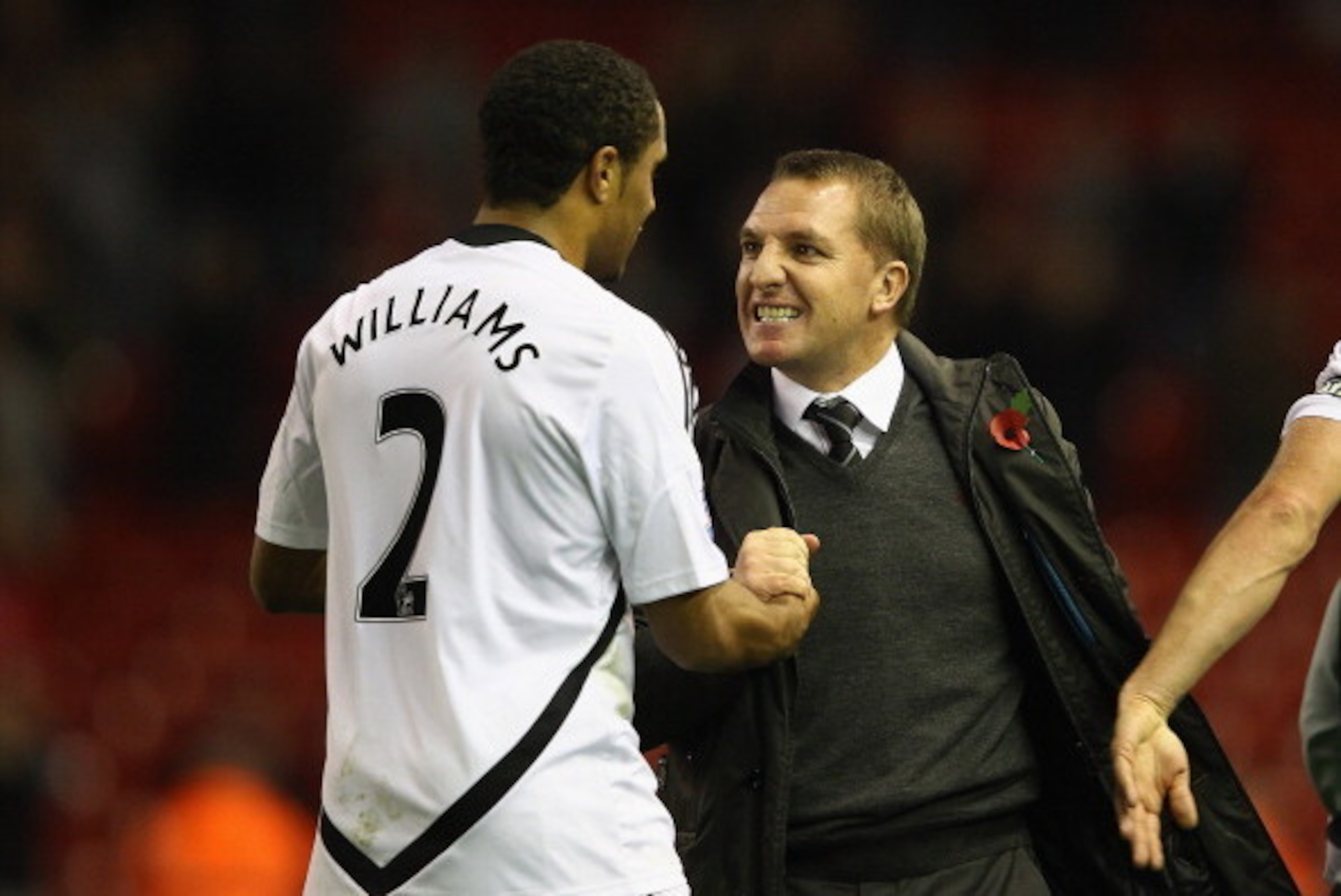 LIVERPOOL, ENGLAND - NOVEMBER 05:  Manager of Swansea City Brendan Rodgers congratulates Ashley Williams of Swansea City after the Barclays Premier League match between Liverpool and Swansea City at Anfield on November 5, 2011 in Liverpool, England.  (Pho