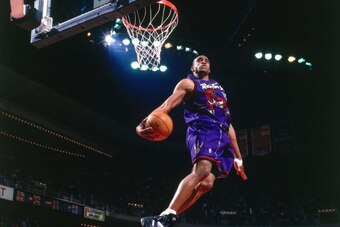 HOUSTON - 1999:  Vince Carter #15 of the Toronto Raptors elevates for a spectacular slam dunk against the Houston Rockets during a 1999 NBA game at the Summit in Houston, Texas.  NOTE TO USER: User expressly acknowledges that, by downloading and or using 