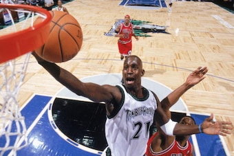 MINNEAPOLIS - DECEMBER 30:  Kevin Garnett #21 of the Minnesota Timberwolves lays up a shot past Antonio Davis #34 of the Chicago Bulls during the game on December 30, 2003 at Target Center in Minneapolis, Minnesota.  The Timberwolves won 98-93.  NOTE TO U