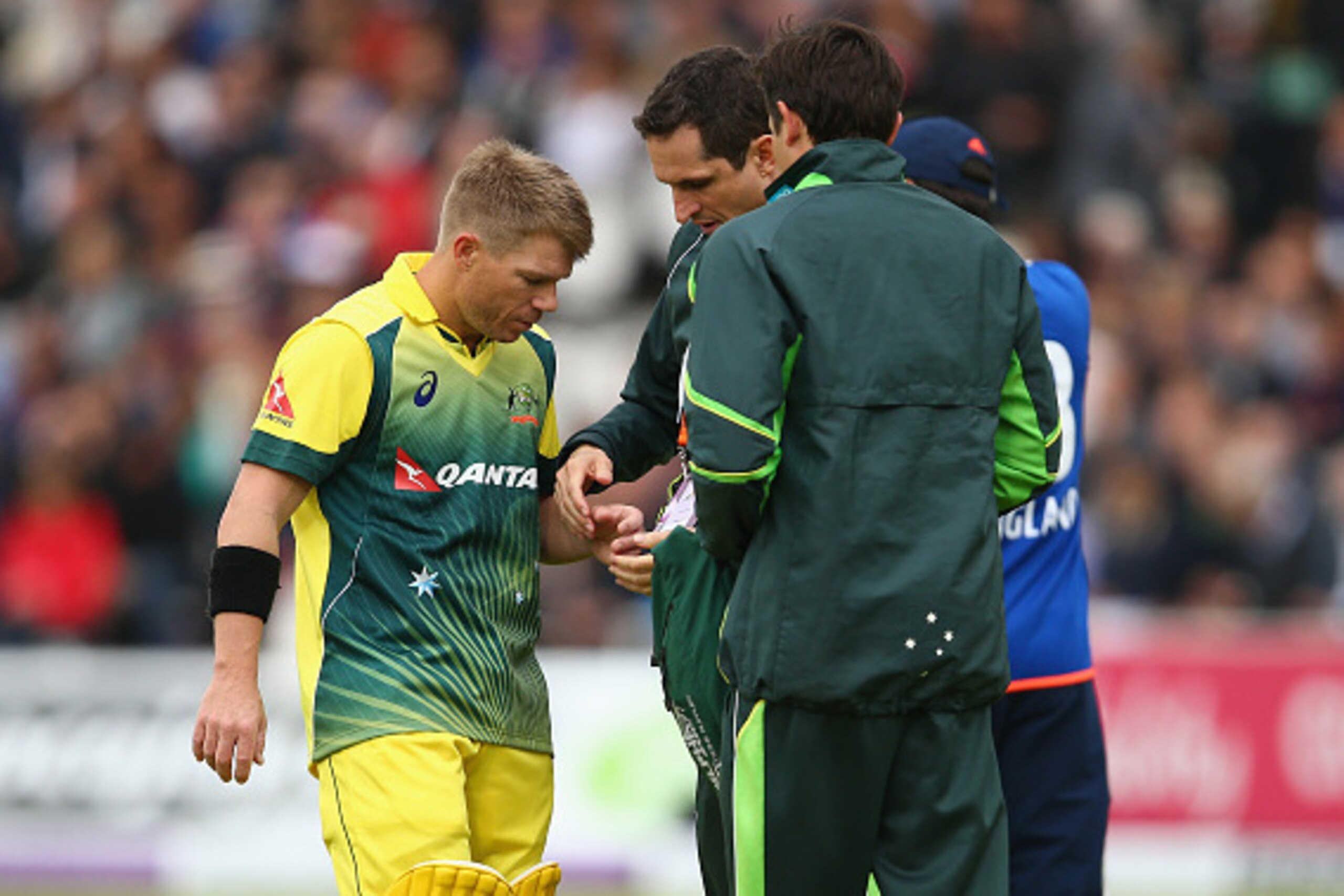 LONDON, ENGLAND - SEPTEMBER 05:  David Warner of Australia receives treatment on his hand after picking up an injury from the bowling of Steven Finn of England during the 2nd Royal London One-Day International match between England and Australia at Lord's