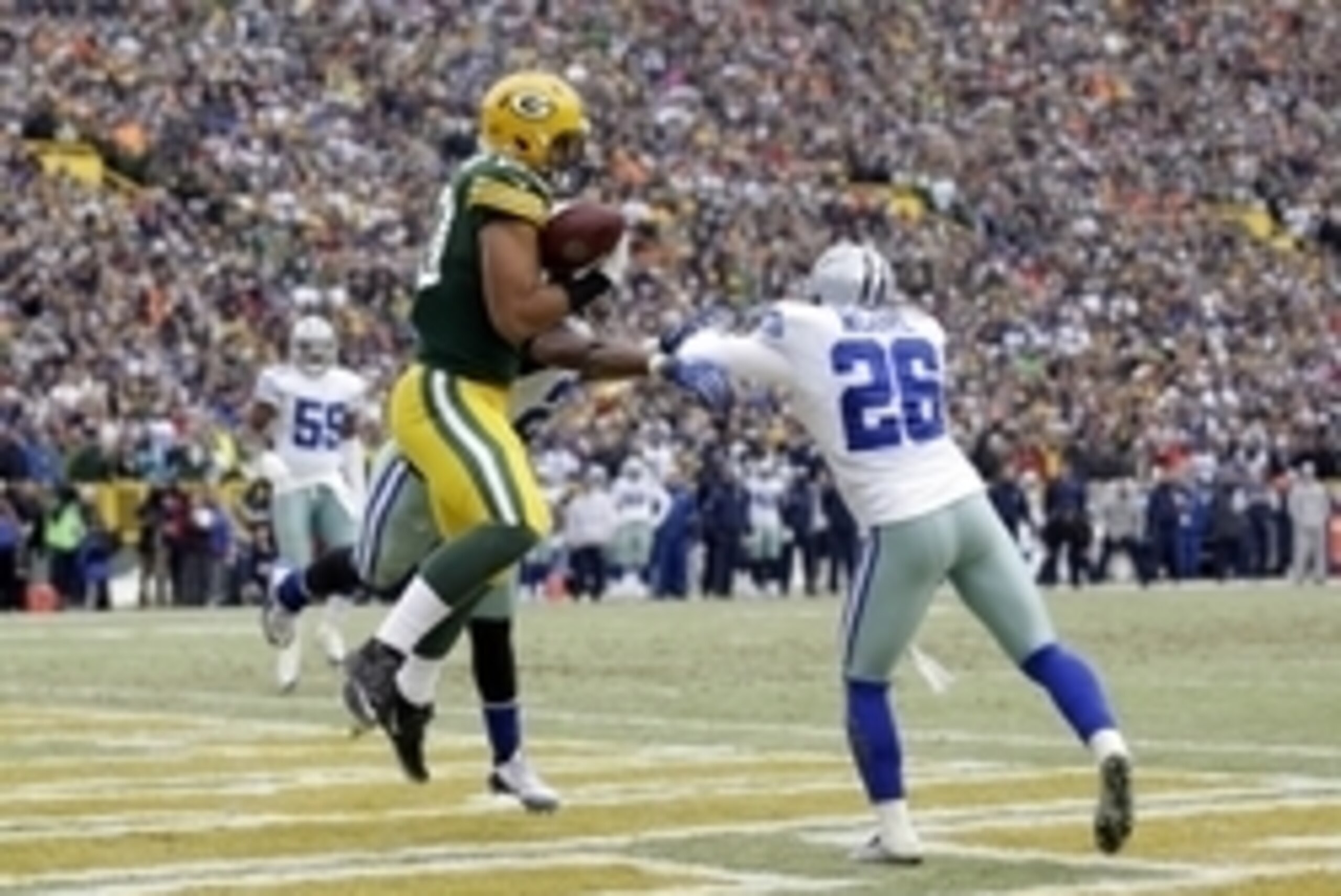 Jan 11, 2015; Green Bay, WI, USA; Green Bay Packers tight end Richard Rodgers (89) catches a pass for a touchdown against Dallas Cowboys defensive back Sterling Moore (26) and free safety J.J. Wilcox (27) in the fourth quarter in the 2014 NFC Divisional p