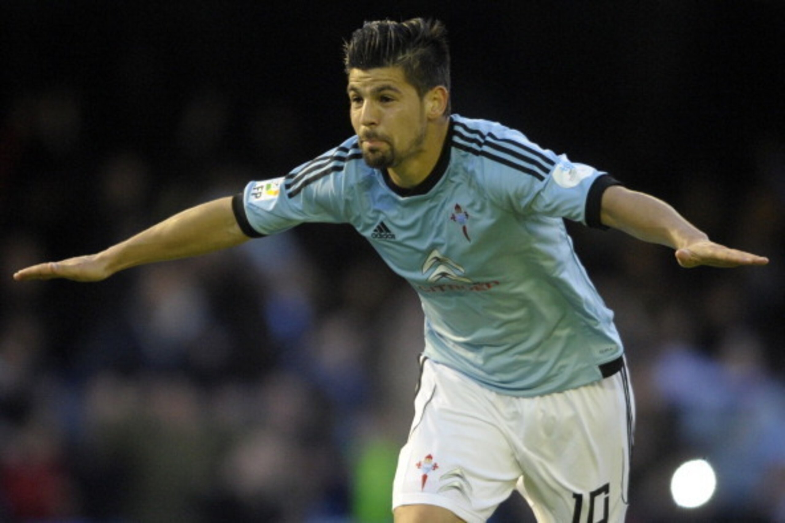 Celta's forward Nolito celebrates after scoring a goal during the Spanish league football match RC Celta de Vigo vs Sevilla FC at the Balaidos stadium in Vigo on March 29, 2014. Celta won the match 1-0.  AFP PHOTO / MIGUEL RIOPA        (Photo credit shoul