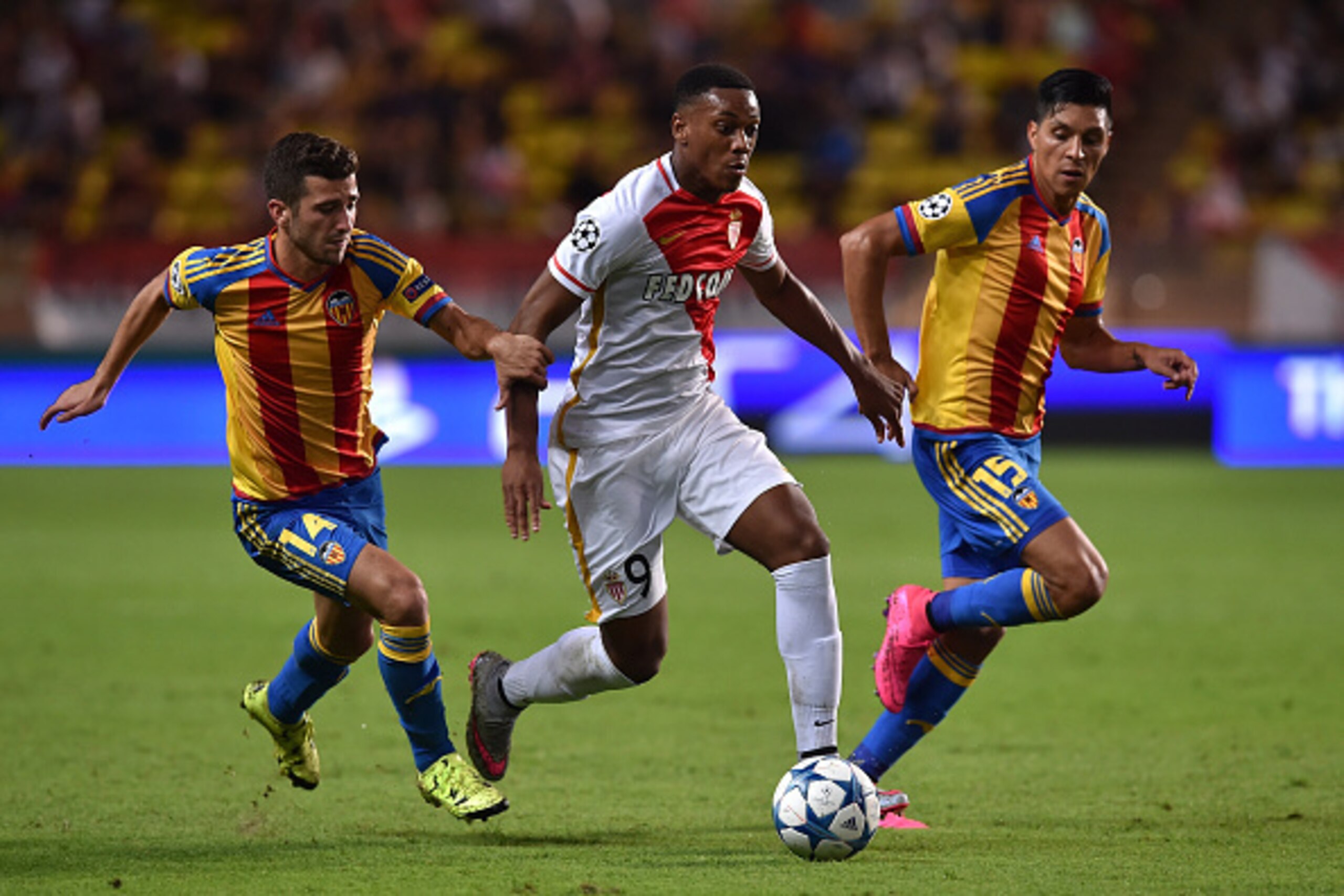 MONACO - AUGUST 25:  Anthony Martial (C) of Monaco is challenged by Jose Gaya (L) and Enzo Perez of Valencia during the UEFA Champions League qualifying round play off second leg match between Monaco and Valencia on August 25, 2015 in Monaco, Monaco.  (Ph