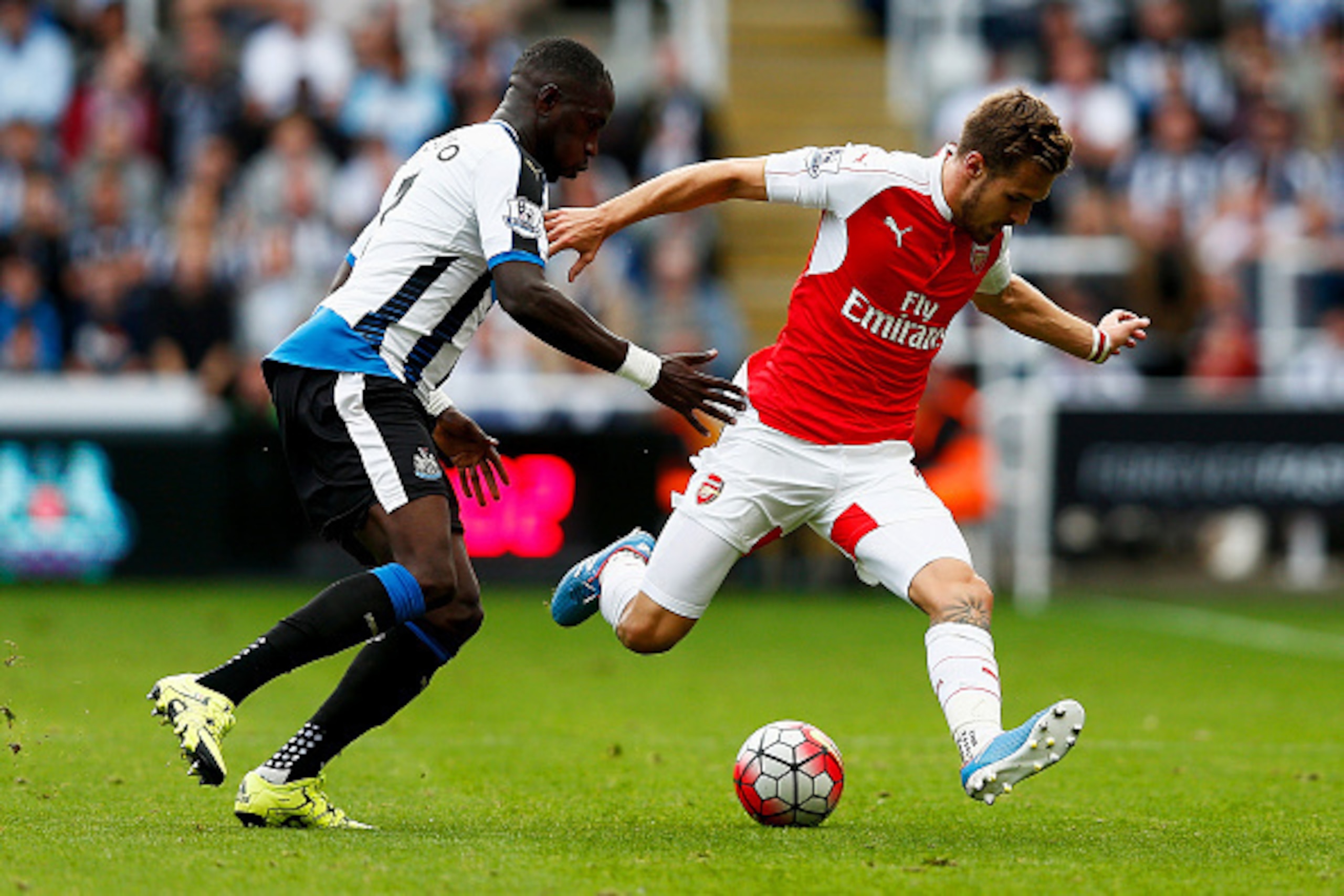 NEWCASTLE UPON TYNE, ENGLAND - AUGUST 29: Aaron Ramsey of Arsenal and Moussa Sissoko of Newcastle United compete for the ball during the Barclays Premier League match between Newcastle United and Arsenal at St James' Park on August 29, 2015 in Newcastle NEWCASTLE UPON TYNE, ENGLAND - AUGUST 29: Aaron Ramsey of Arsenal and Moussa Sissoko of Newcastle United compete for the ball during the Barclays Premier League match between Newcastle United and Arsenal at St James' Park on August 29, 2015 in Newcastle