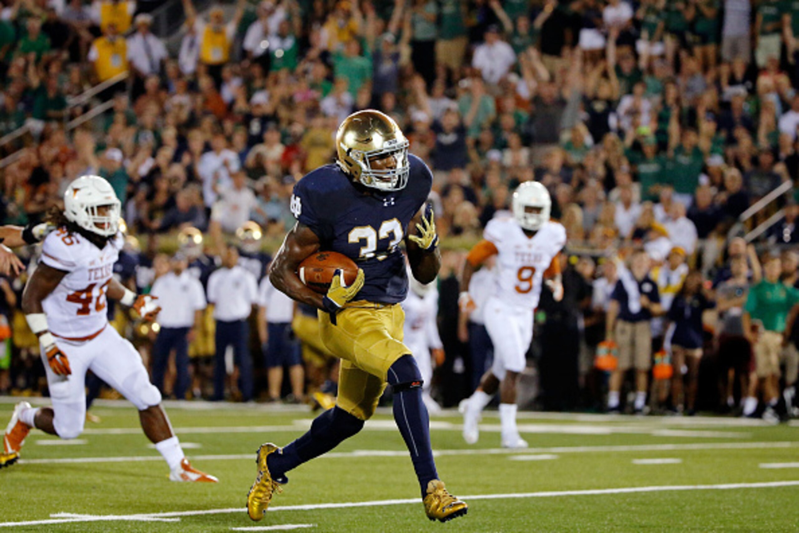 SOUTH BEND, IN - SEPTEMBER 05: Josh Adams #33 of the Notre Dame Fighting Irish rushes for a touchdown against the Texas Longhorns during the third quarter at Notre Dame Stadium on September 5, 2015 in South Bend, Indiana. The Notre Dame Fighting Irish won