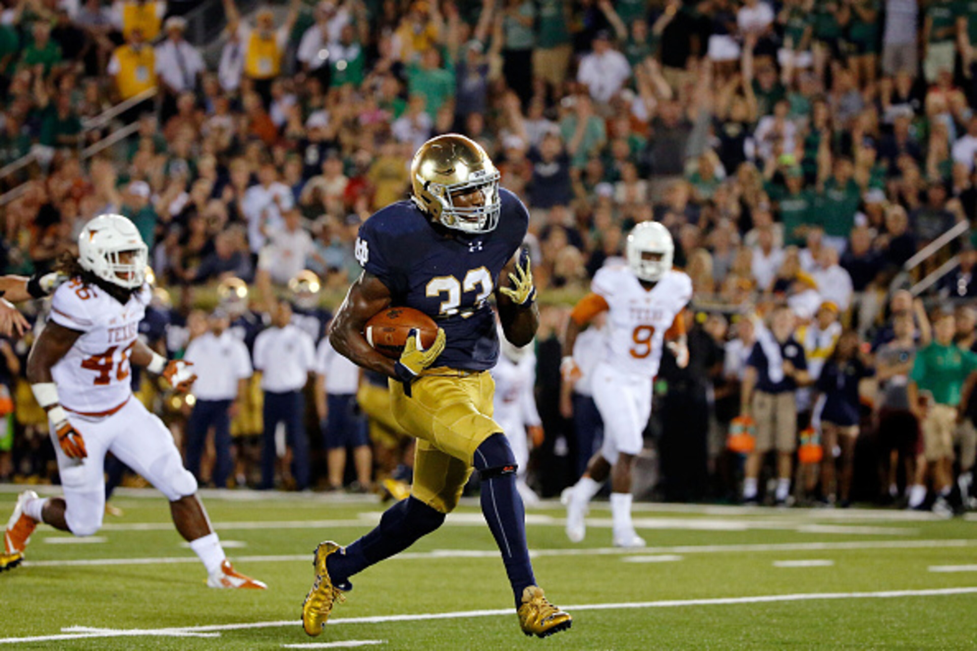 SOUTH BEND, IN - SEPTEMBER 05: Josh Adams #33 of the Notre Dame Fighting Irish rushes for a touchdown against the Texas Longhorns during the third quarter at Notre Dame Stadium on September 5, 2015 in South Bend, Indiana. The Notre Dame Fighting Irish won SOUTH BEND, IN - SEPTEMBER 05: Josh Adams #33 of the Notre Dame Fighting Irish rushes for a touchdown against the Texas Longhorns during the third quarter at Notre Dame Stadium on September 5, 2015 in South Bend, Indiana. The Notre Dame Fighting Irish won