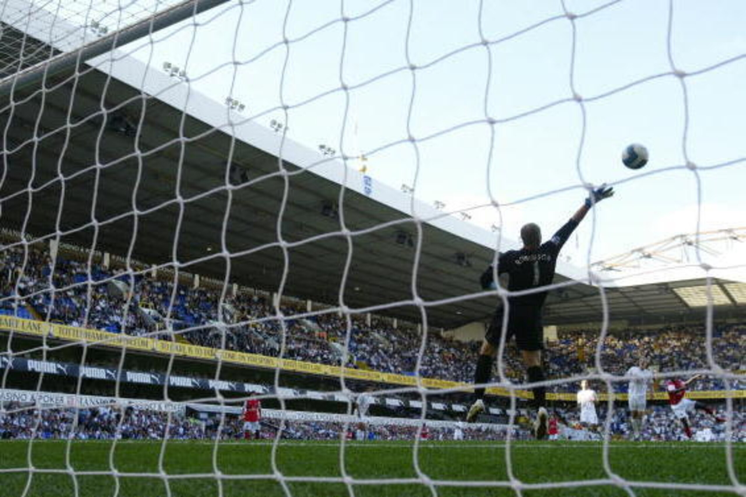 LONDON - SEPTEMBER 15:  Emmanuel Adebayor of Arsenal scores his 2nd goal past Paul Robinson of Tottenham during the Barclays Premier League match between Tottenham Hotspur and Arsenal at White Hart Lane on September 15, 2007 in London, England.  (Photo by