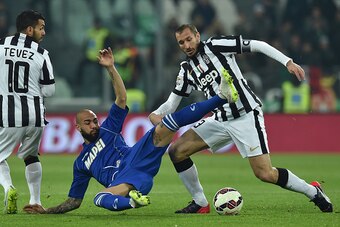 TURIN, ITALY - MARCH 09:  Simone Zaza (C) of US Sassuolo Calcio is tackled by Giorgio Chiellini (R) and Carlos Tevez of Juventus FC during the Serie A match between Juventus FC and US Sassuolo Calcio at Juventus Arena on March 9, 2015 in Turin, Italy.  (P