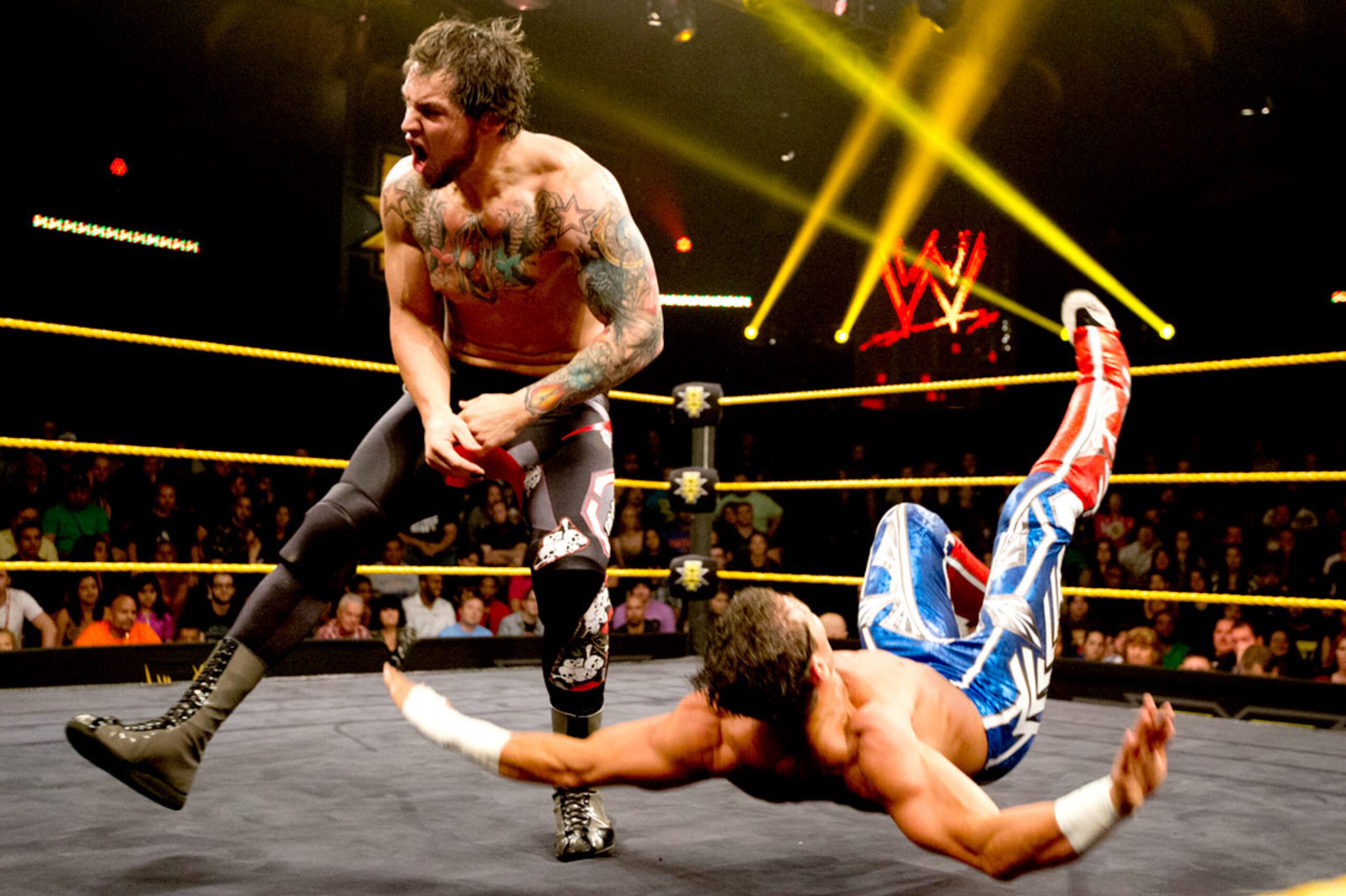 Baron Corbin bowls over Tyson Kidd.