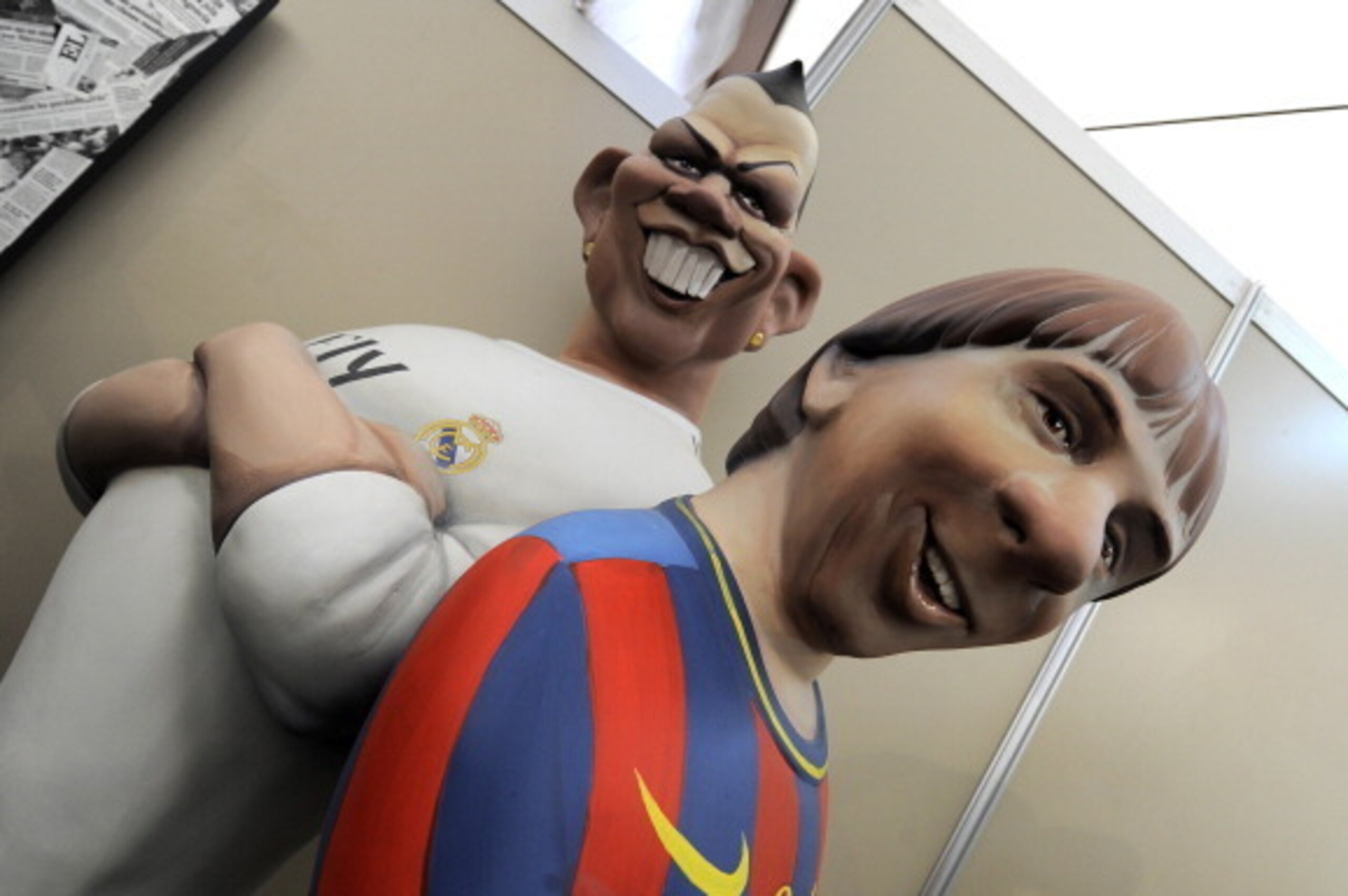 Ninots (individual figure making up the scenes in the Fallas celebration) of Real Madrid's Portuguese forward Cristiano Ronaldo (L) and Barcelona's Argentinian forward Lionel Messi, that will be set alight during the Fallas are on display on March 13, 201