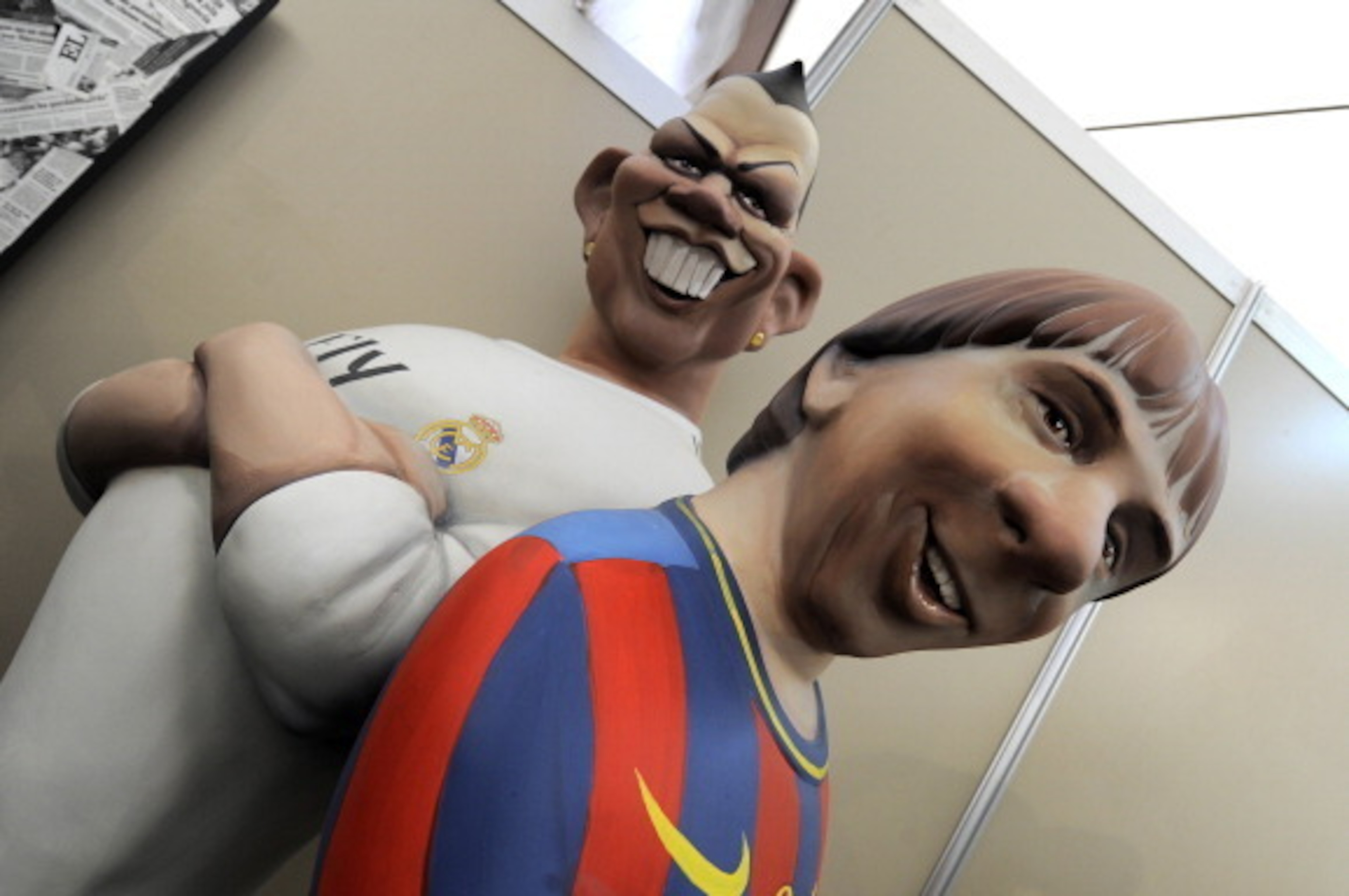 Ninots (individual figure making up the scenes in the Fallas celebration) of Real Madrid's Portuguese forward Cristiano Ronaldo (L) and Barcelona's Argentinian forward Lionel Messi, that will be set alight during the Fallas are on display on March 13, 201 Ninots (individual figure making up the scenes in the Fallas celebration) of Real Madrid's Portuguese forward Cristiano Ronaldo (L) and Barcelona's Argentinian forward Lionel Messi, that will be set alight during the Fallas are on display on March 13, 201
