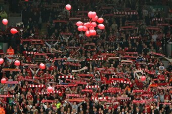 LIVERPOOL, ENGLAND - APRIL 15:  The Liverpool Kop End sing 'You'll Never Walk Alone' as red balloons for each of the 96 Hillsborough victims are released during the Hillsborough memorial at Anfield on April 15, 2009, Liverpool, England.  Thousands of fans