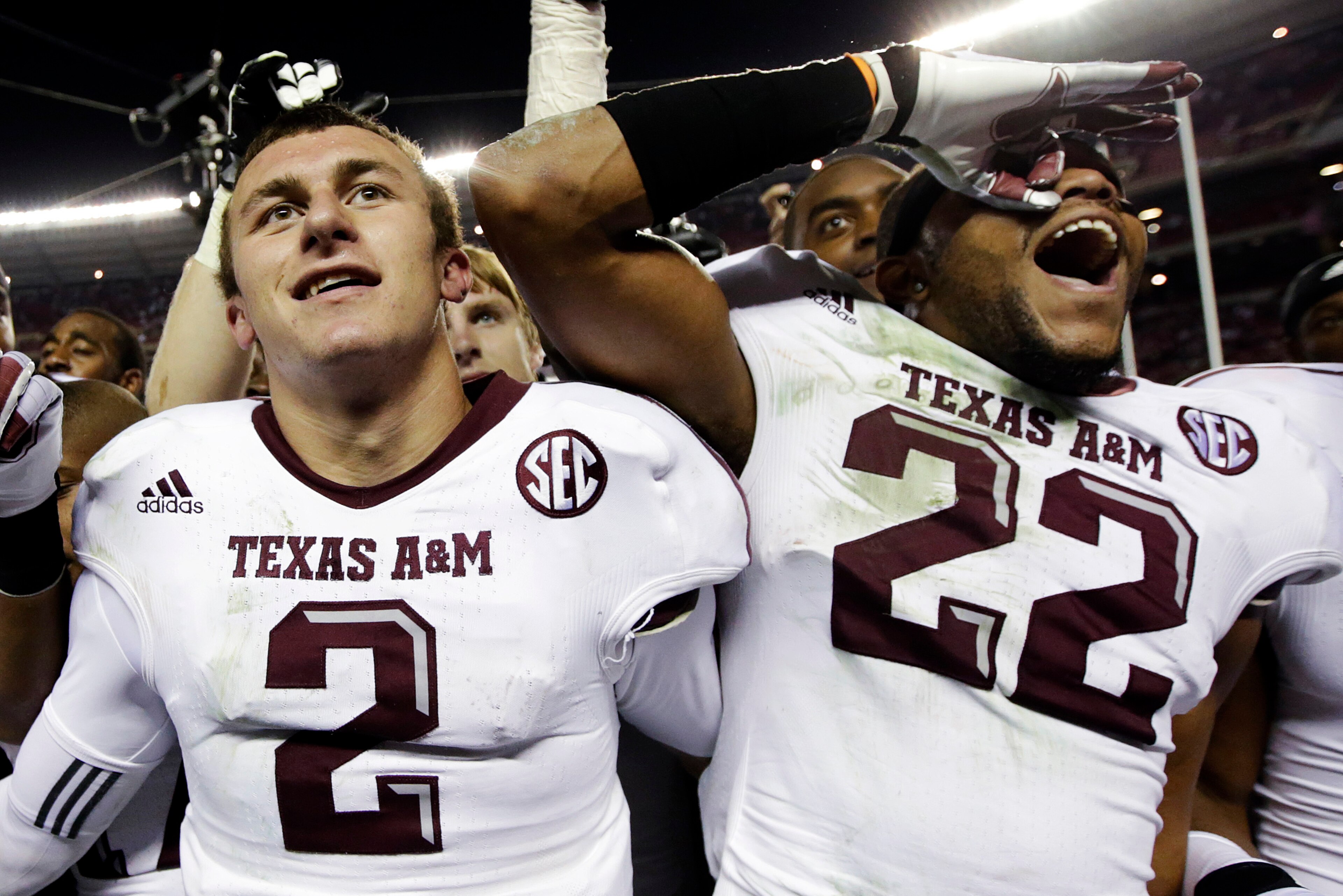 Johnny Manziel and Texas A&M teammate Dustin Harris celebrate after their 2012 upset of Alabama in Tuscaloosa.
