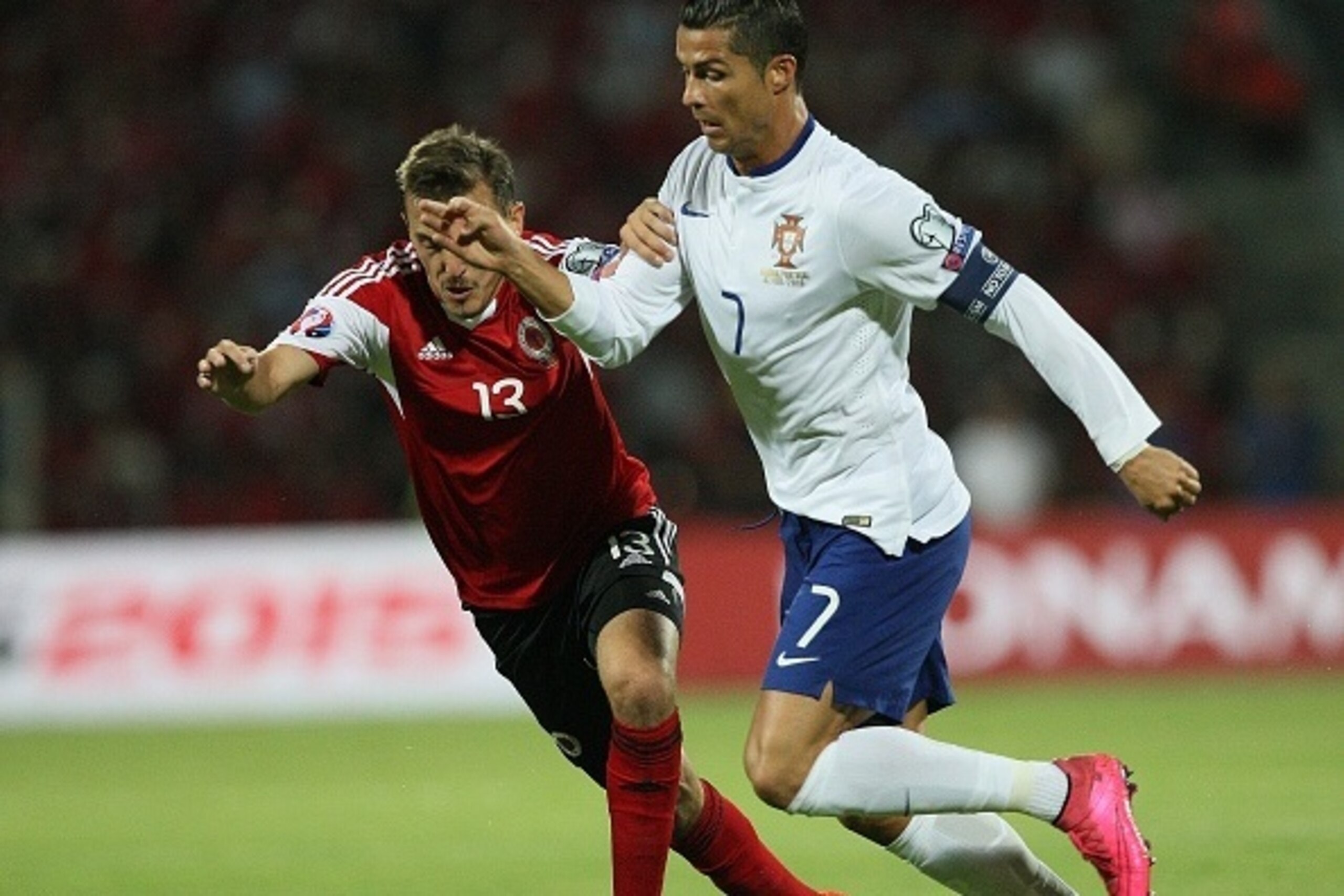 Albania's Burim Kukeli (L) vies with Portugal's Cristiano Ronaldo (R) during the Euro 2016 qualifying football match between Albania and Portuhgal at the Elbasan Arena in Elbasan on September 7, 2015. AFP PHOTO / GENT SHKULLAKU        (Photo credit should