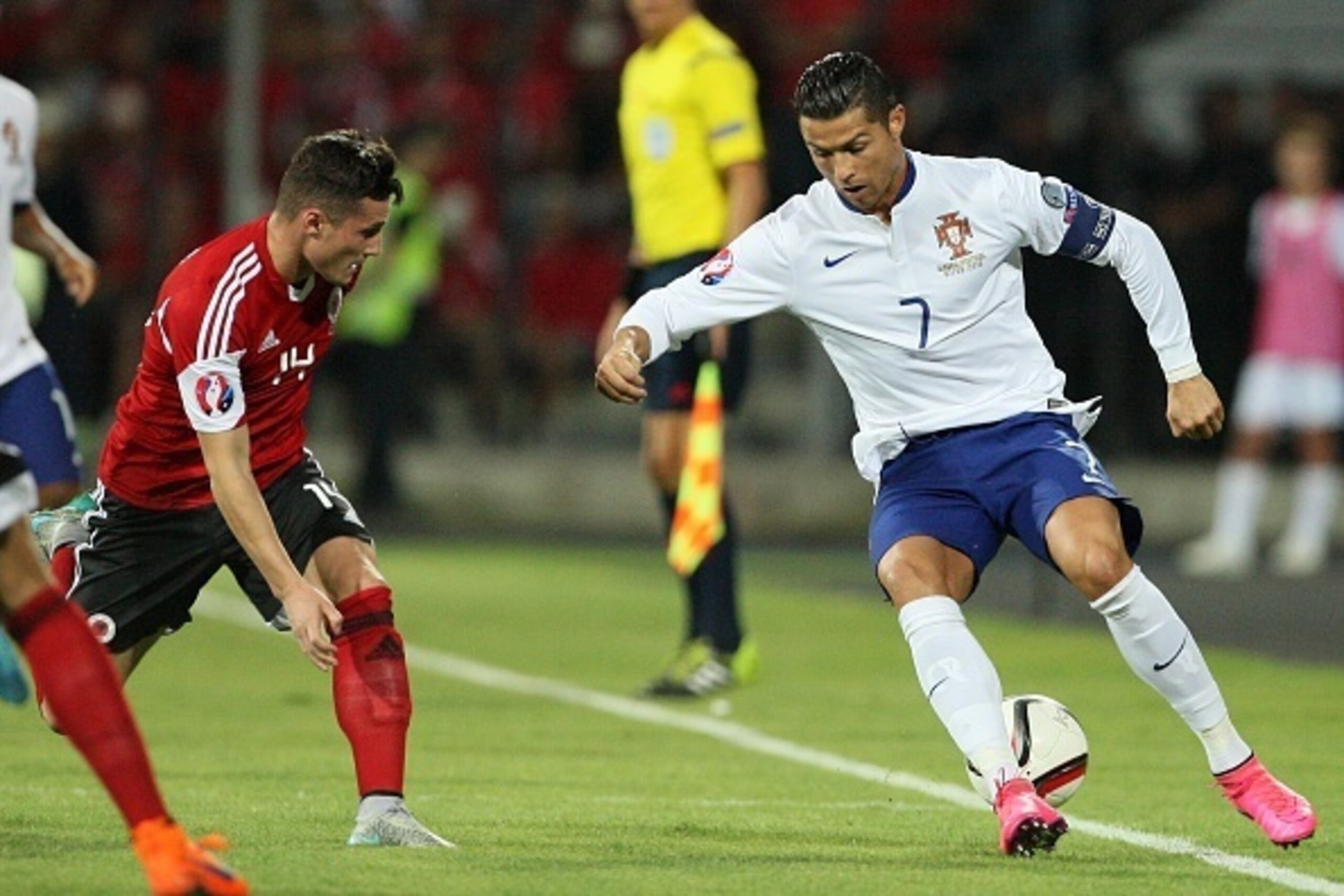 Albania's Taulant Xhaka vies with Portugal's Cristiano Ronaldo (R) during the Euro 2016 qualifying football match between Albania and Portugal at the Elbasan Arena in Elbasan on September 7, 2015. AFP PHOTO / GENT SHKULLAKU        (Photo credit should rea