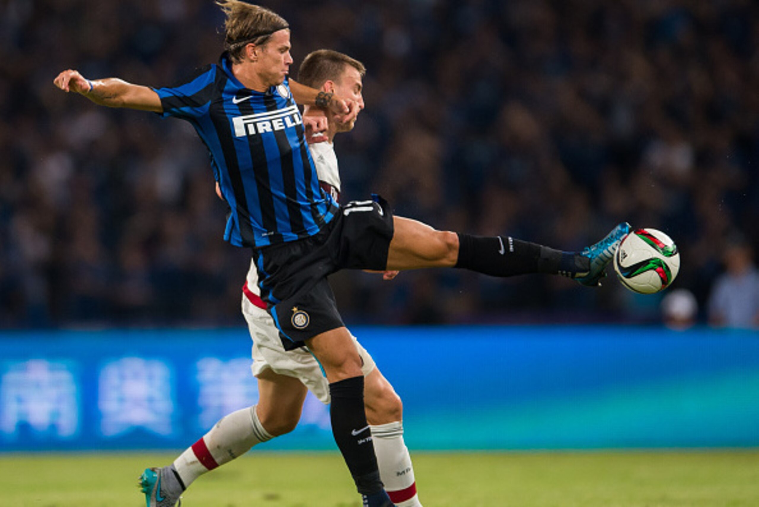 SHENZHEN, CHINA - JULY 25:  Samuele Longo of FC Internazionale Milano (L) competes for the ball with Rodrigo Ely of AC Milan during the AC Milan vs FC Internacionale as part of the International Champions Cup 2015 at the looks onnggang Stadium on July 25,