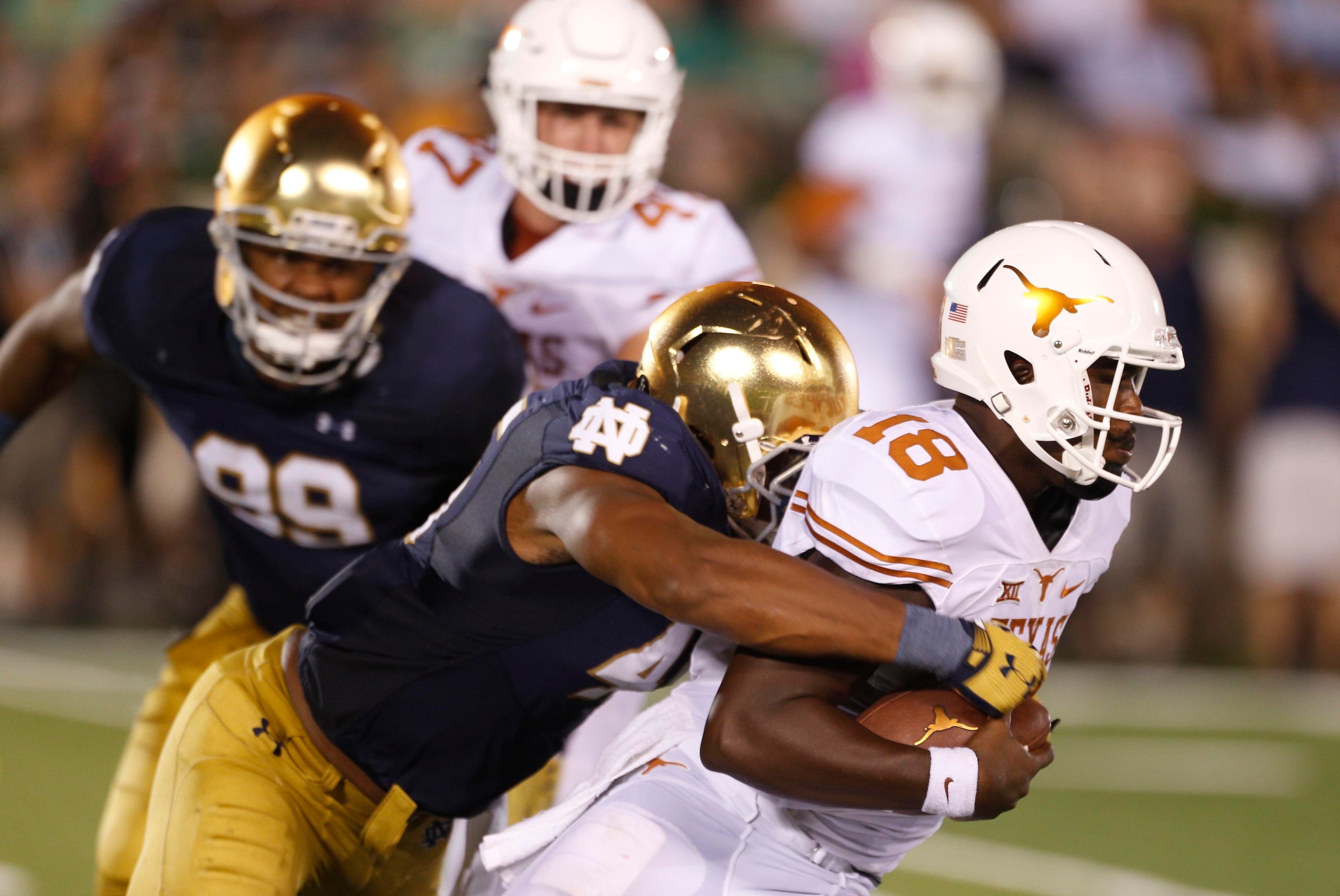 Sep 5, 2015; South Bend, IN, USA; Texas Longhorns  quarterback Tyrone Swoopes (18) is sacked by Notre Dame Fighting Irish defensive lineman Romeo Okwara (45) at Notre Dame Stadium. Notre Dame defeats Texas 38-3. Mandatory Credit: Brian Spurlock-USA TODAY