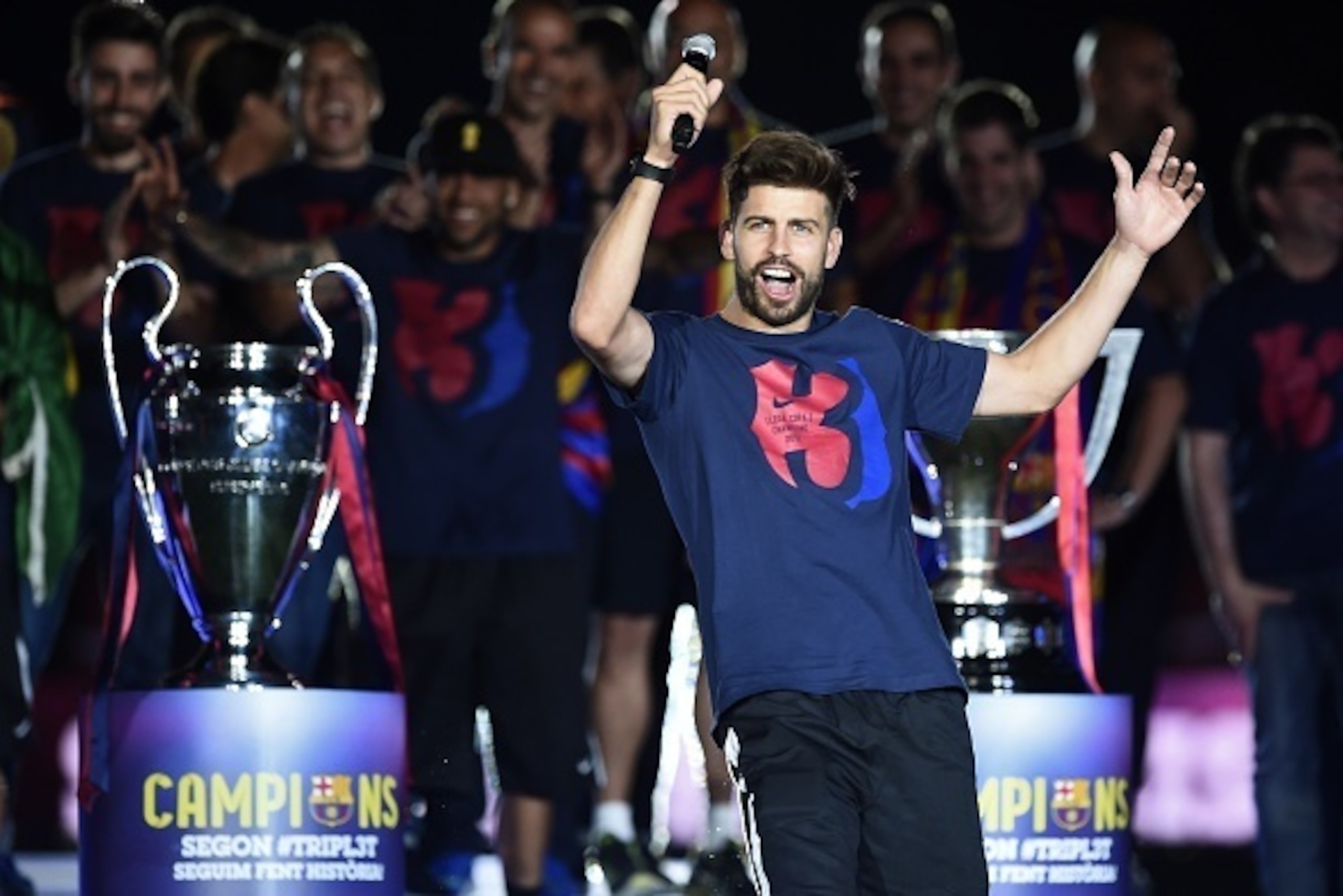 Barcelona's defender Gerard Pique delivers a speech as he takes part in the celebrations held for their victory over Juventus, one day after the UEFA Champions League final football, at the Camp Nou stadium in Barcelona on June 7, 2015. Luis Suarez and Ne