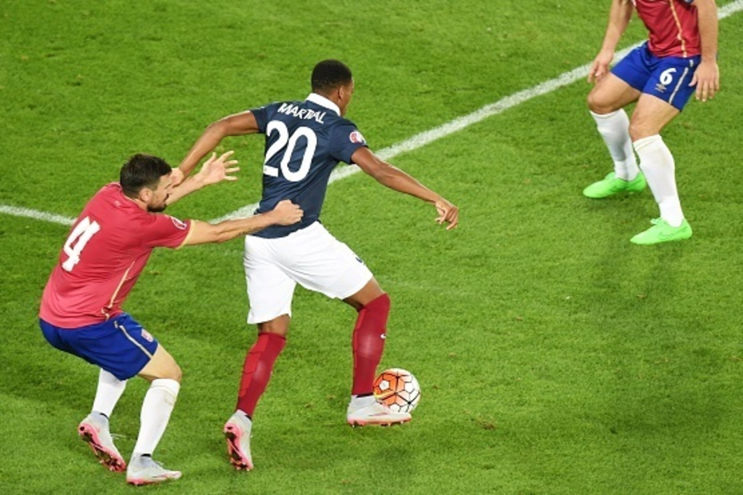 Serbias defender Nenad Tomovic (L) vies with France's Anthony Martial (C) during the Euro 2016 friendly football match France vs Serbia at the Matmut Atlantique stadium in Bordeaux on September 7, 2015. France defeated Serbia 2-1. AFP PHOTO / MEHDI FEDOUA