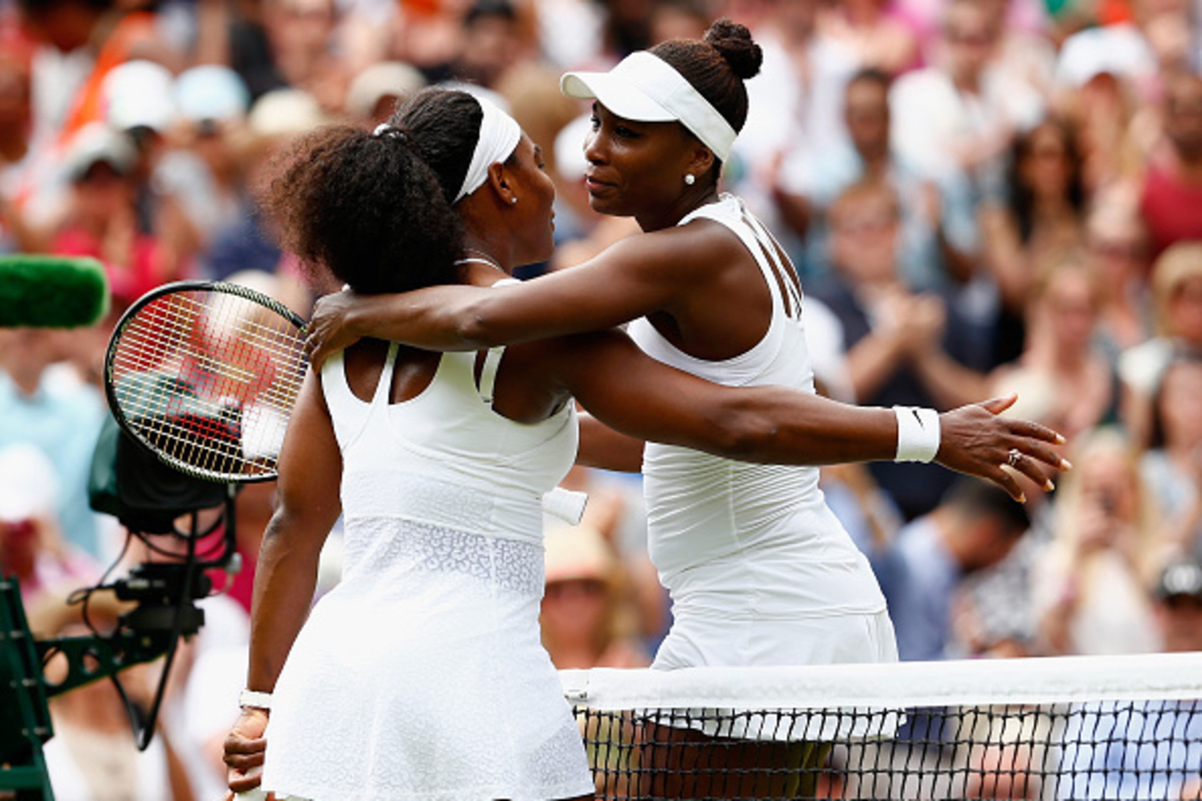 LONDON, ENGLAND - JULY 06: Serena Williams of the United States hugs Venus Williams of the United States after their Ladies' Singles Fourth Round match during day seven of the Wimbledon Lawn Tennis Championships at the All England Lawn Tennis and Croque LONDON, ENGLAND - JULY 06: Serena Williams of the United States hugs Venus Williams of the United States after their Ladies' Singles Fourth Round match during day seven of the Wimbledon Lawn Tennis Championships at the All England Lawn Tennis and Croque