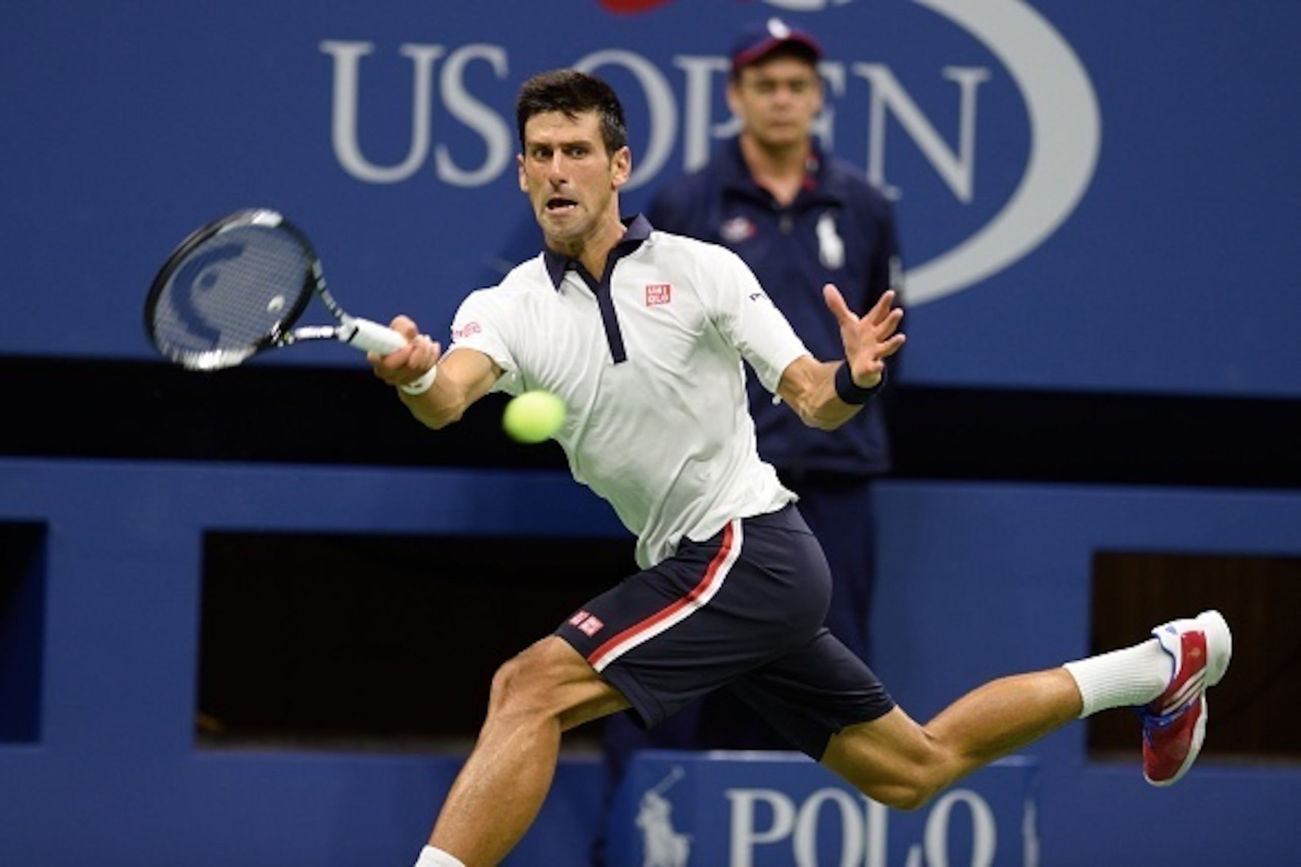 Novak Djokovic of Serbia hits a return to Roberto Bautista Agut from Spain during their US Open 2015 fourth round men's singles match at the USTA Billie Jean King National Tennis Center on September 6, 2015  in New York. AFP PHOTO/DON EMMERT        (Photo