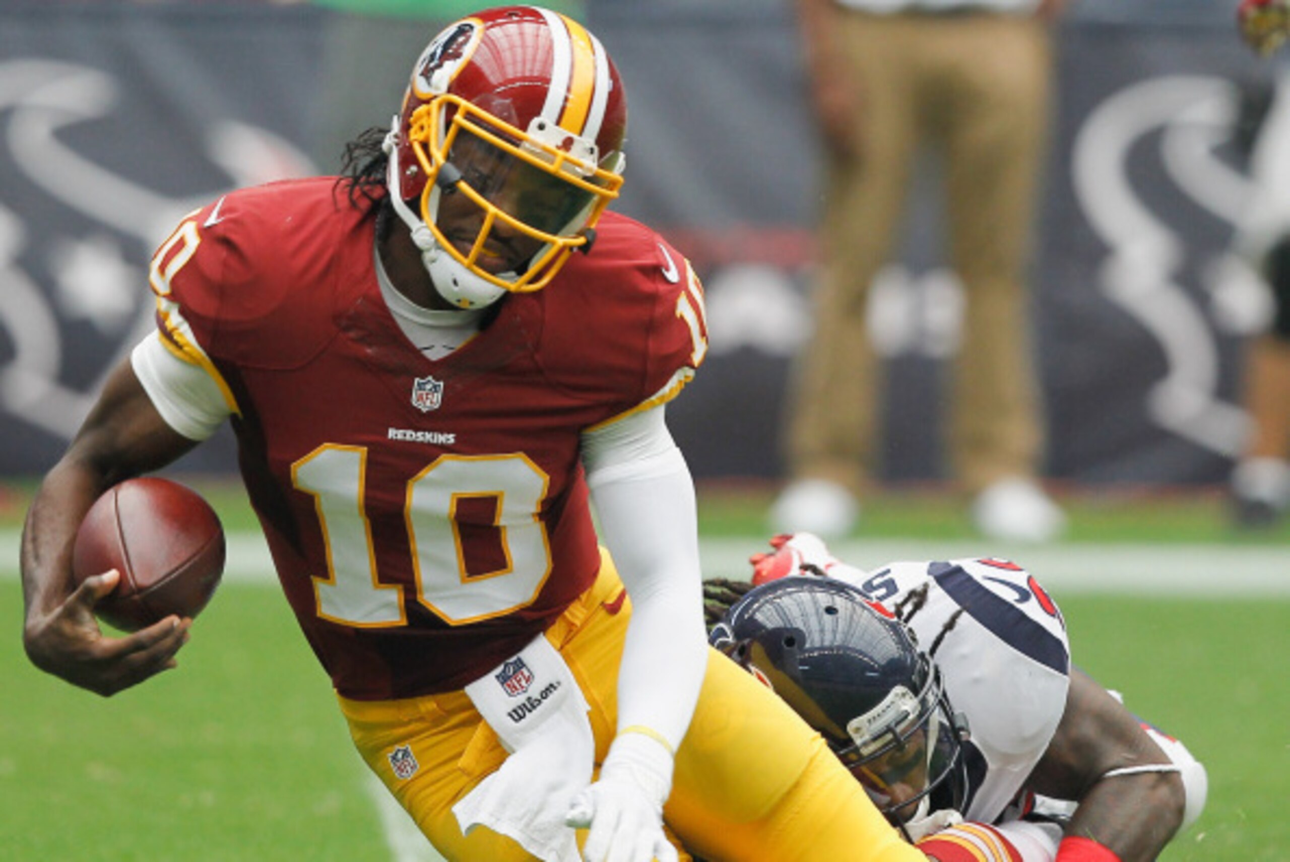 HOUSTON, TX - SEPTEMBER 07:  Robert Griffin III #10 of the Washington Redskins is sacked by D.J. Swearinger #36 of the Houston Texans at Reliant Stadium on September 7, 2014 in Houston, Texas.  (Photo by Bob Levey/Getty Images)