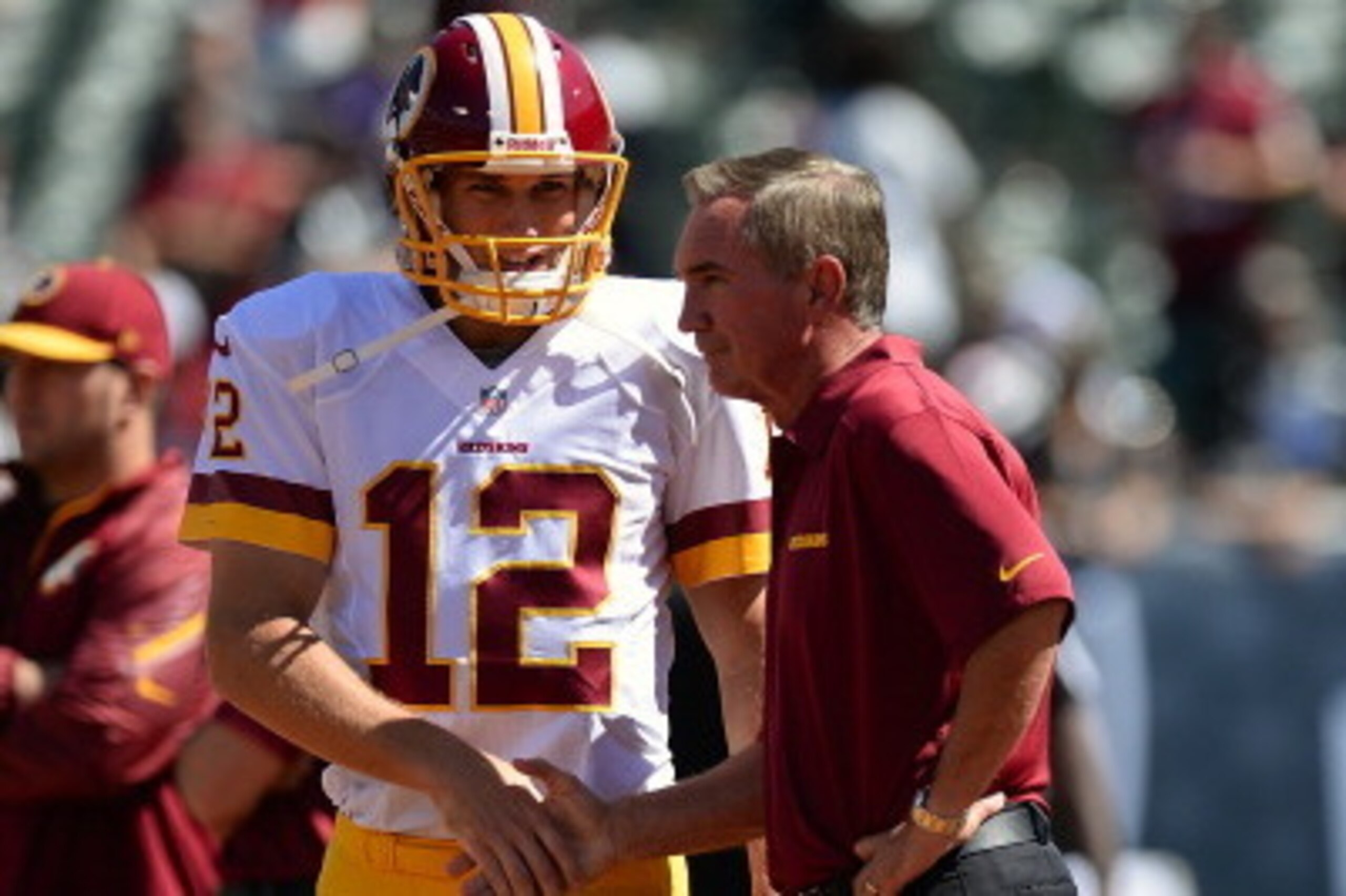 OAKLAND, CA - SEPTEMBER 29:  Head Coach Mike Shanahan of the Washington Redskins shakes the hand of quarterback Kirk Cousins #12 during pre-game warm ups prior to playing the Oakland Raiders at O.co Coliseum on September 29, 2013 in Oakland, California.  