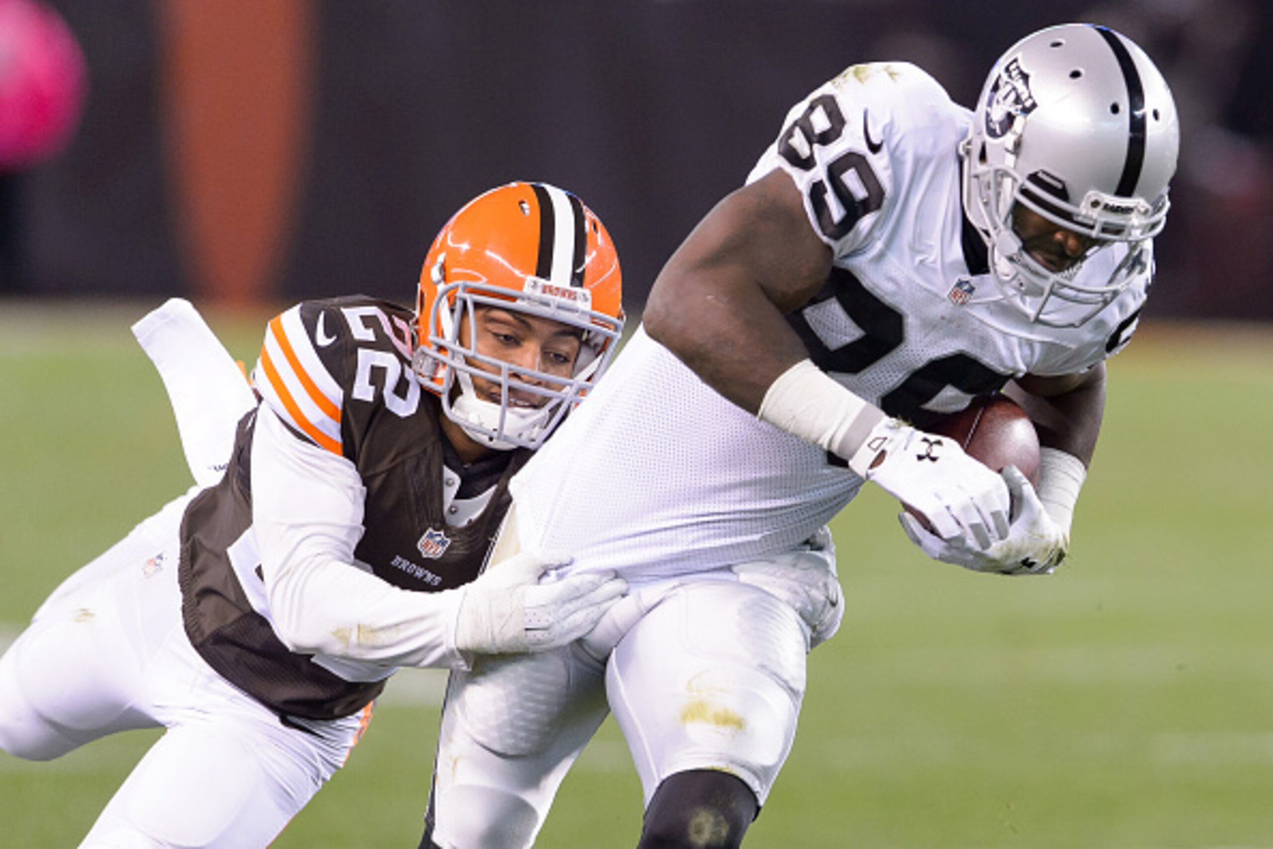 CLEVELAND, OH - OCTOBER 26: Cornerback Buster Skrine #22 of the Cleveland Browns tackles wide receiver James Jones #89 of the Oakland Raiders during the second half at FirstEnergy Stadium in Cleveland, Ohio. The Browns defeated the Raiders 23-13. (Photo b