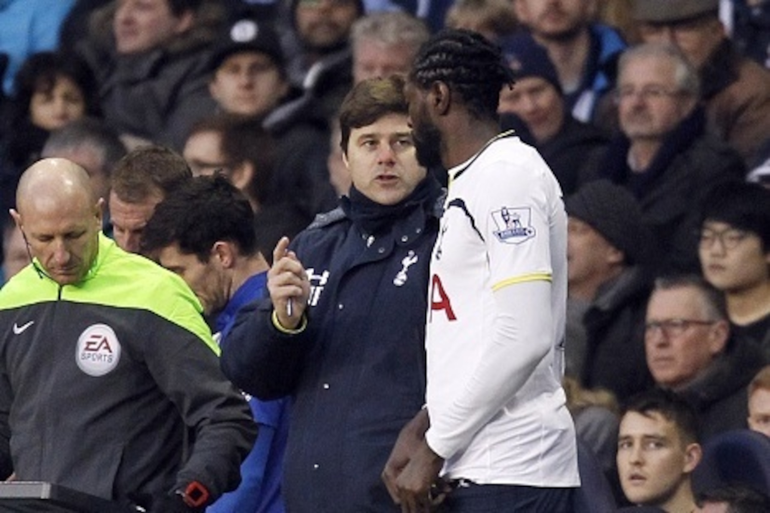 Tottenham Hotspurs Argentinian head coach Mauricio Pochettino talks to Tottenham Hotspur's Togolese striker Emmanuel Adebayor before he comes on as a substitute during the FA Cup fourth round football match between Tottenham Hotspur and Leicester City at 
