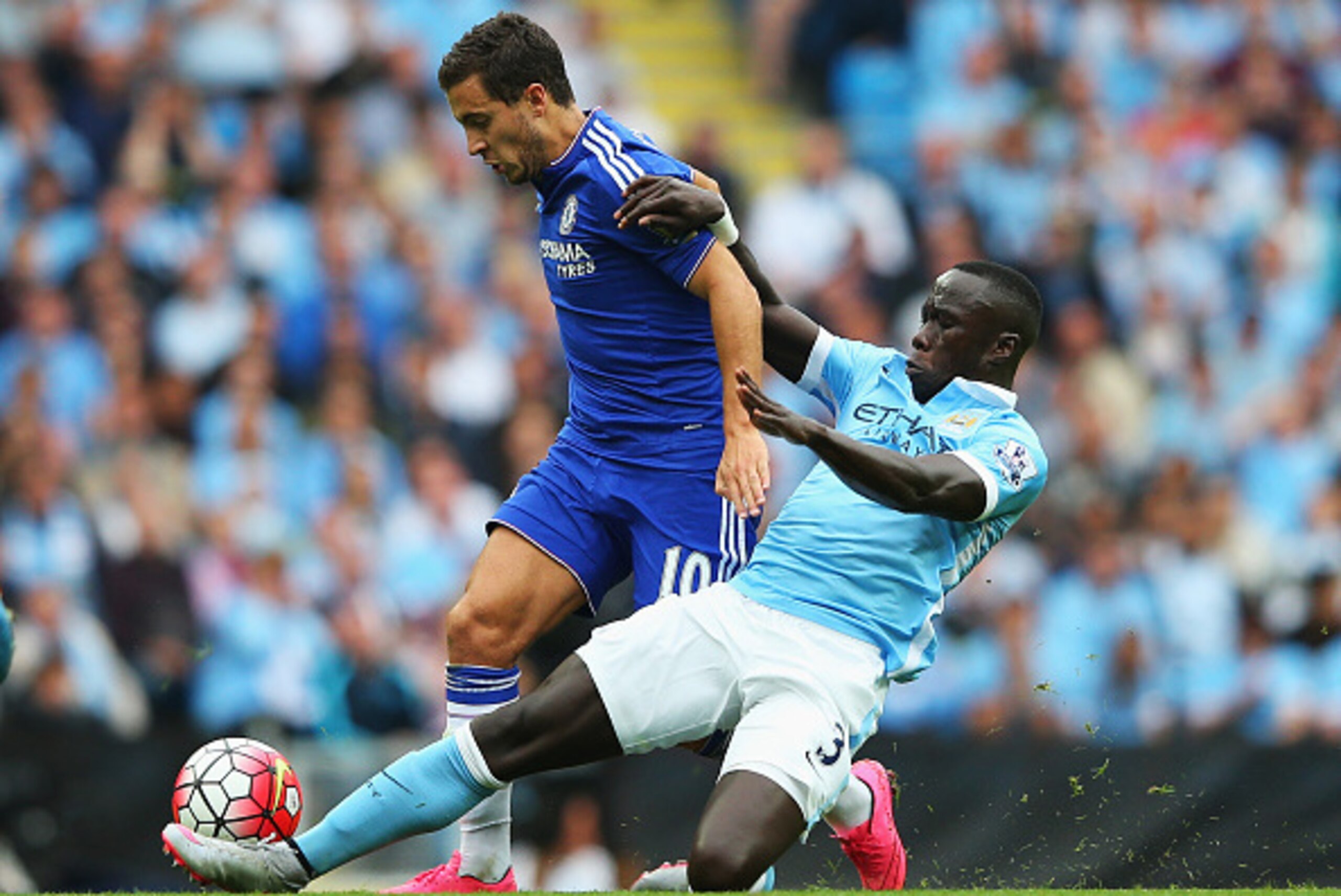 MANCHESTER, ENGLAND - AUGUST 16: Eden Hazard of Chelsea is tackled by Bacary Sagna of Manchester City during the Barclays Premier League match between Manchester City and Chelsea at the Etihad Stadium on August 16, 2015 in Manchester, England.  (Photo by 