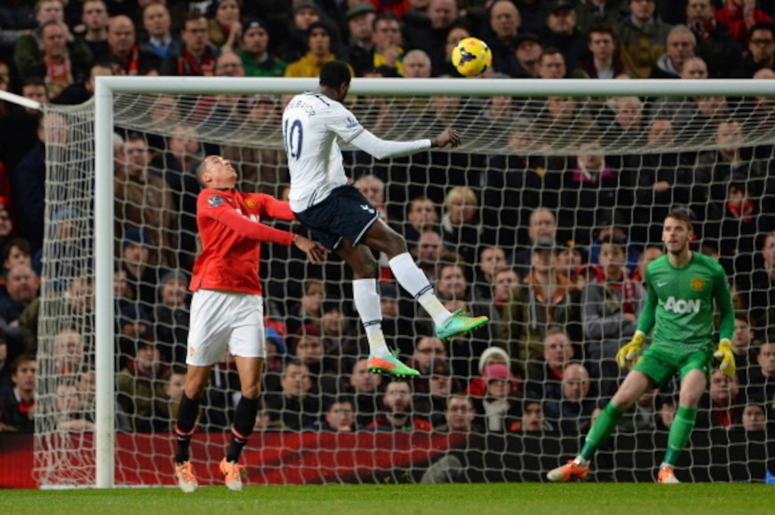 MANCHESTER, ENGLAND - JANUARY 01:   Emmanuel Adebayor of Tottenham Hotspur scores the opening goal during the Barclays Premier League match between Manchester United and Tottenham Hotspur at Old Trafford on January 1, 2014 in Manchester, England.  (Photo 