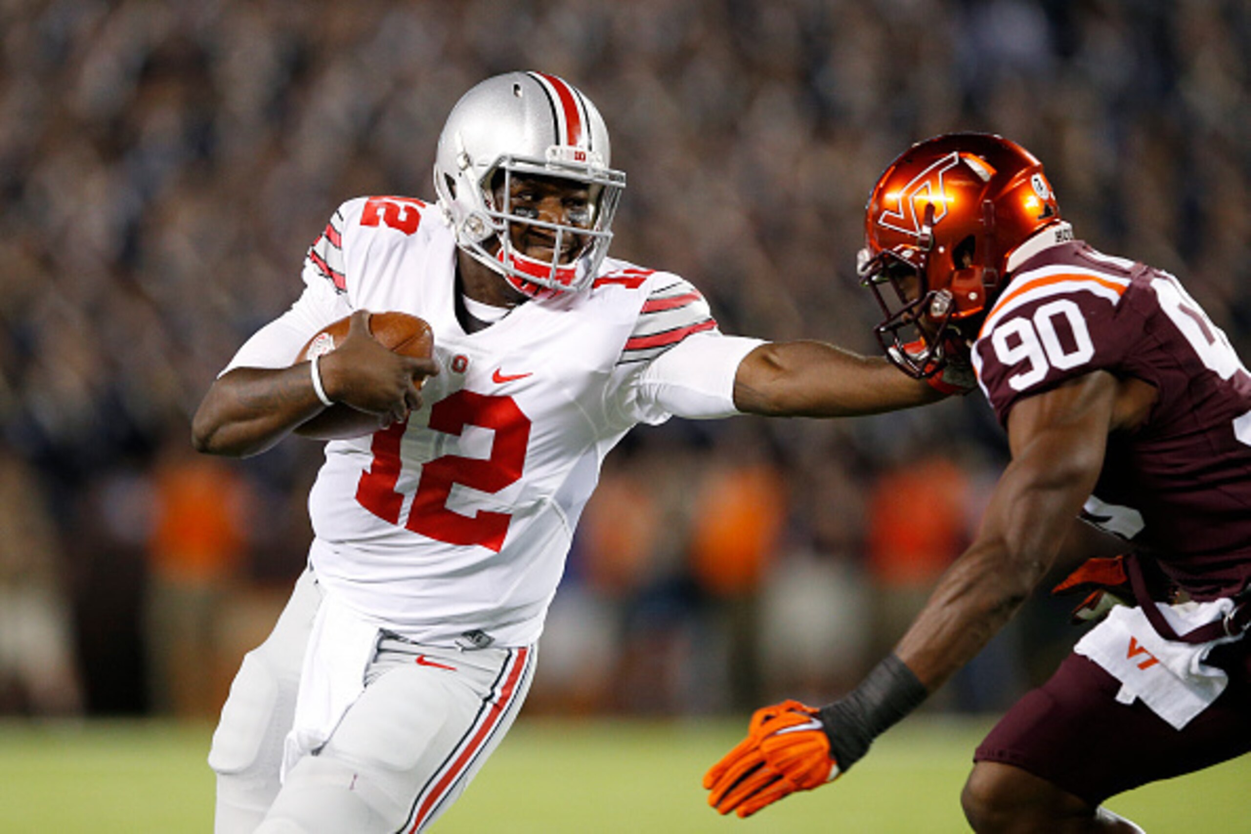 BLACKSBURG, VA - SEPTEMBER 7: Cardale Jones #12 of the Ohio State Buckeyes tries to run the ball past Dadi L'homme Nicolas #90 of the Virginia Tech Hokies in the first quarter at Lane Stadium on September 7, 2015 in Blacksburg, Virginia. (Photo by Joe Rob
