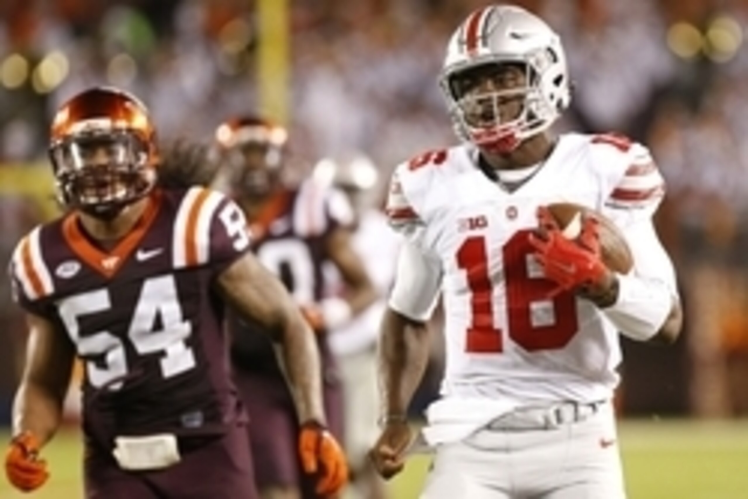 Sep 7, 2015; Blacksburg, VA, USA; Ohio State Buckeyes quarterback J.T. Barrett (16) runs with the ball as Virginia Tech Hokies linebacker Andrew Motuapuaka (54) chases in the fourth quarter at Lane Stadium. The Buckeyes won 42-24. Mandatory Credit: Geoff 