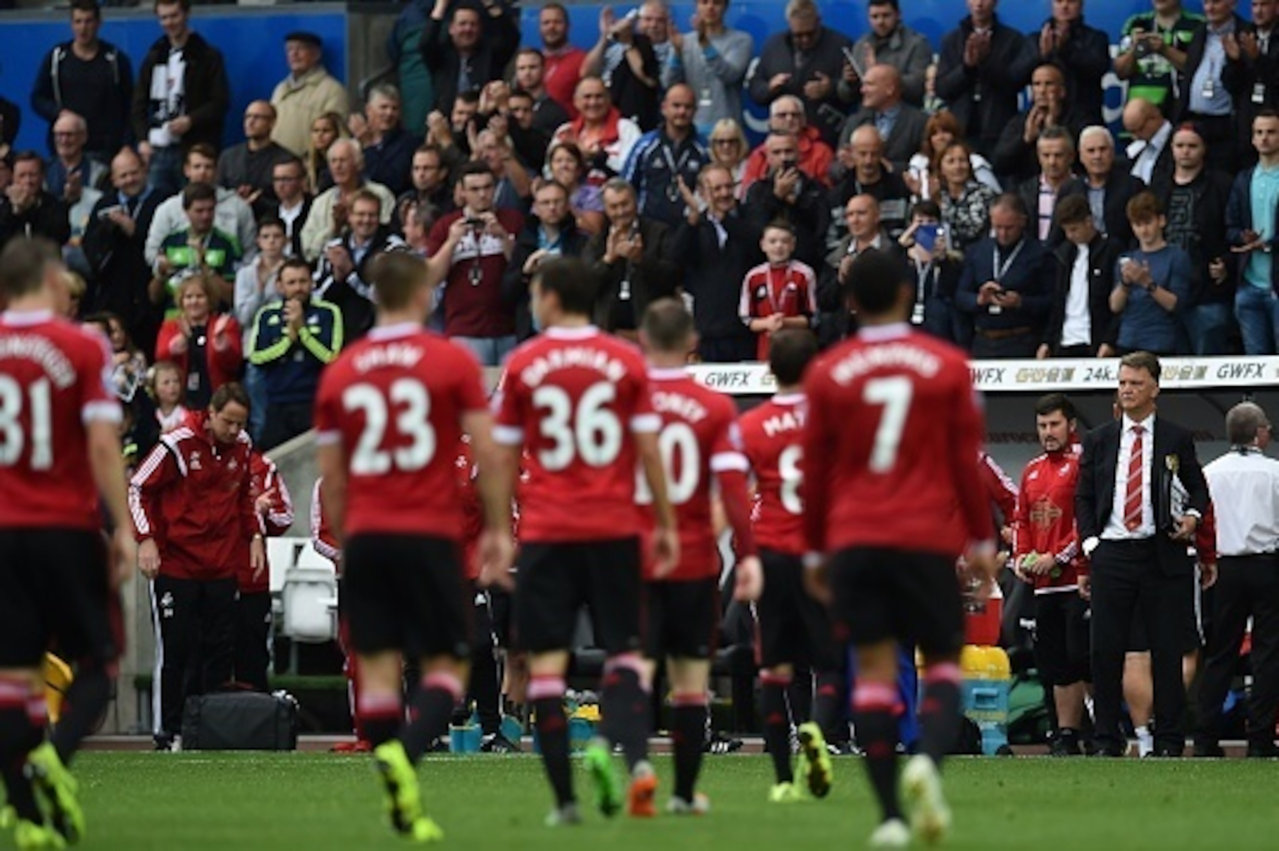 Manchester United's Dutch manager Louis van Gaal (R) watches his players leave the pitch following the English Premier League football match between Swansea City and Manchester United at The Liberty Stadium in Swansea, south Wales on August 30, 2015. Swan
