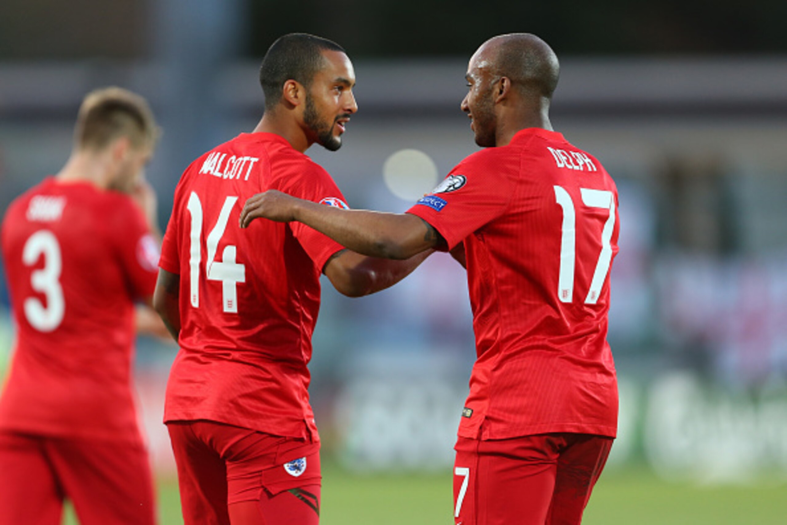 SAN MARINO, ITALY - SEPTEMBER 05:  Theo Walcott of England celebrates after scoring to make it 0-4 with Fabian Delph during the UEFA Euro 2016 Qualifier Group E match between San Marino and England at Stadio Olimpico on September 5, 2015 in San Marino, It