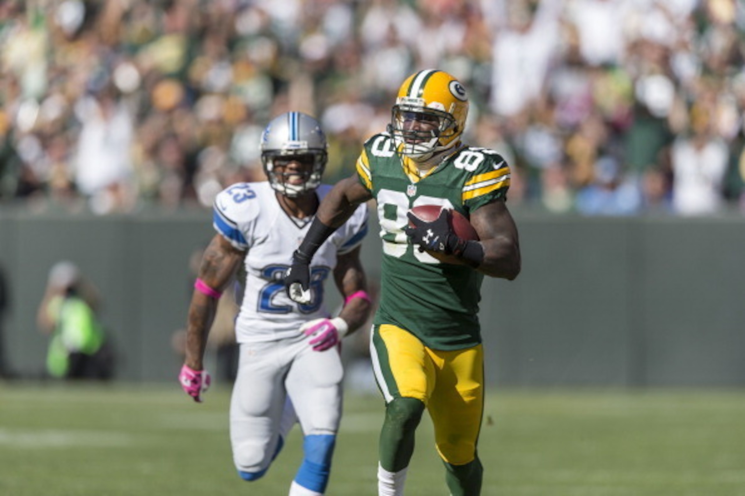 GREEN BAY, WI - OCTOBER 6:  James Jones #89 of the Green Bay Packers out runs Chris Houston #23 of the Detroit Lions for a touchdown at Lambeau Field on October 6, 2013 in Green Bay, Wisconsin.  (Photo Tom Lynn /Getty Images)